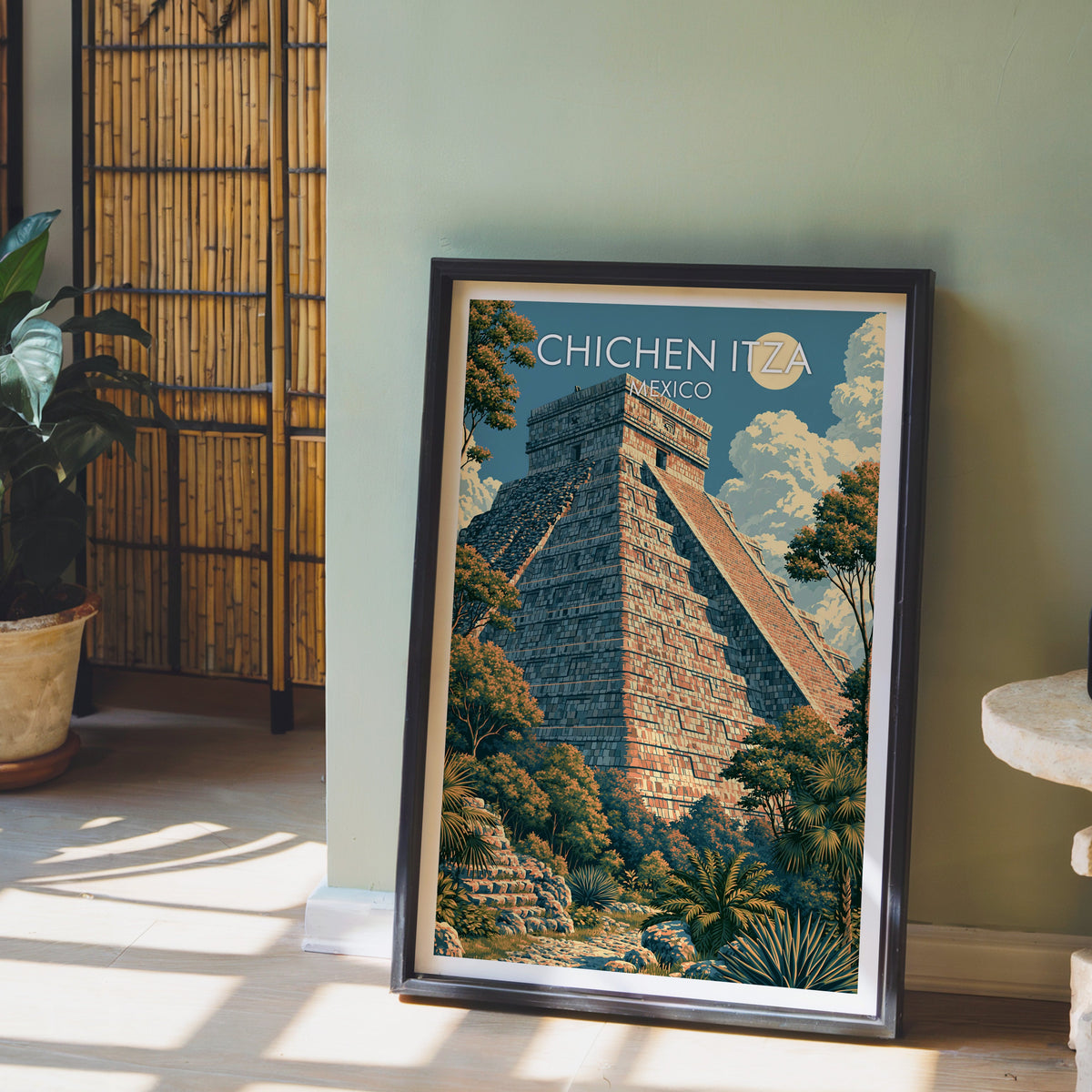 Teal sky and apricot stone print, black frame leaning on pale wood floor by a sage-green wall and bamboo screen