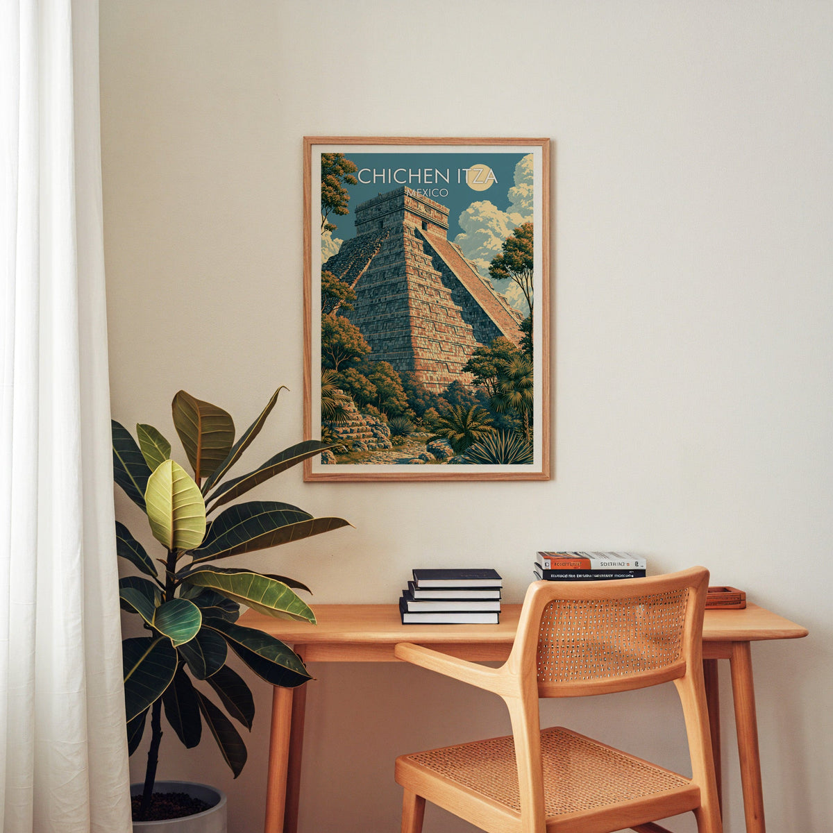 Teal and apricot Chichen Itza print in an oak frame above a home-office desk with cane chair and plant