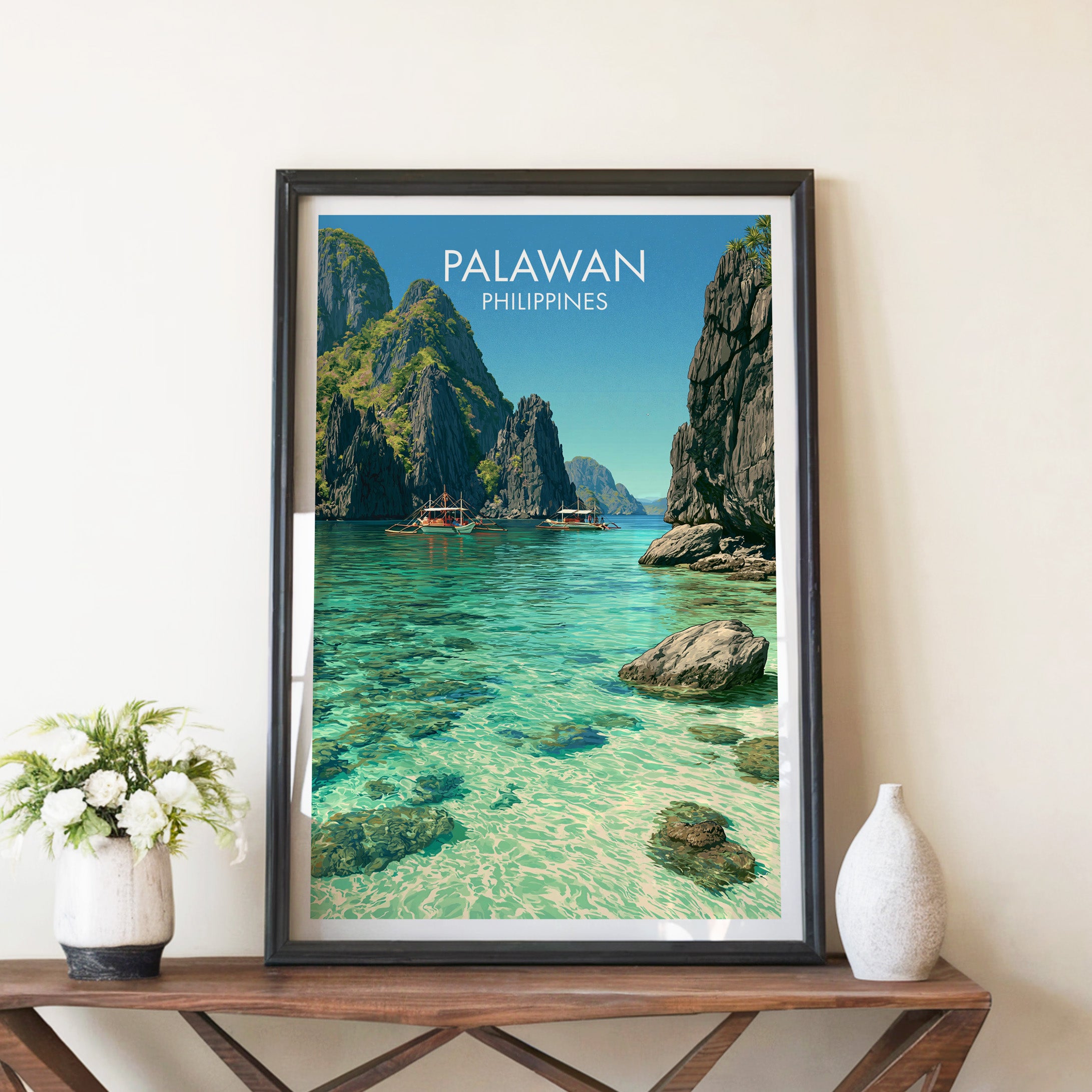 El Nido Palawan Philippines travel poster in a black frame on a wooden console table with white flowers