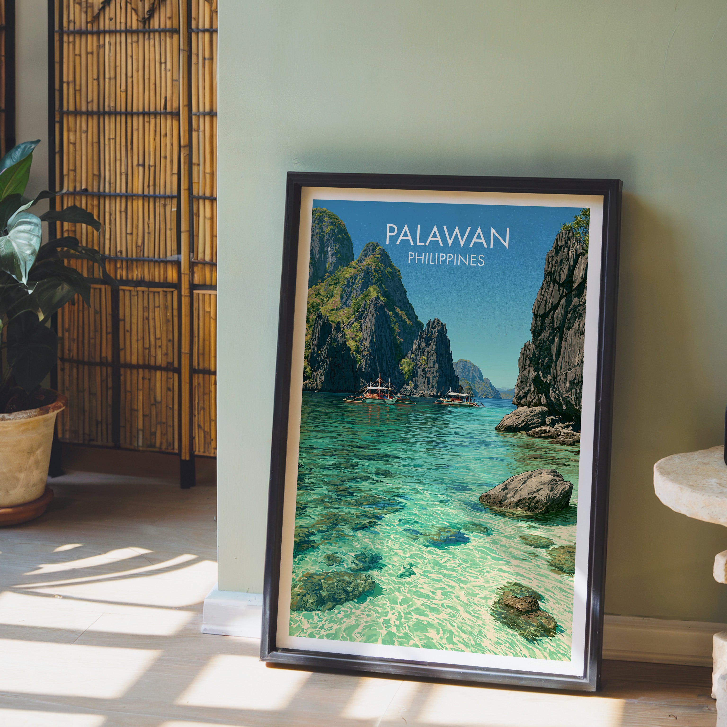 El Nido Palawan Philippines wall art in a black frame leaning against a sage green wall beside a bamboo screen