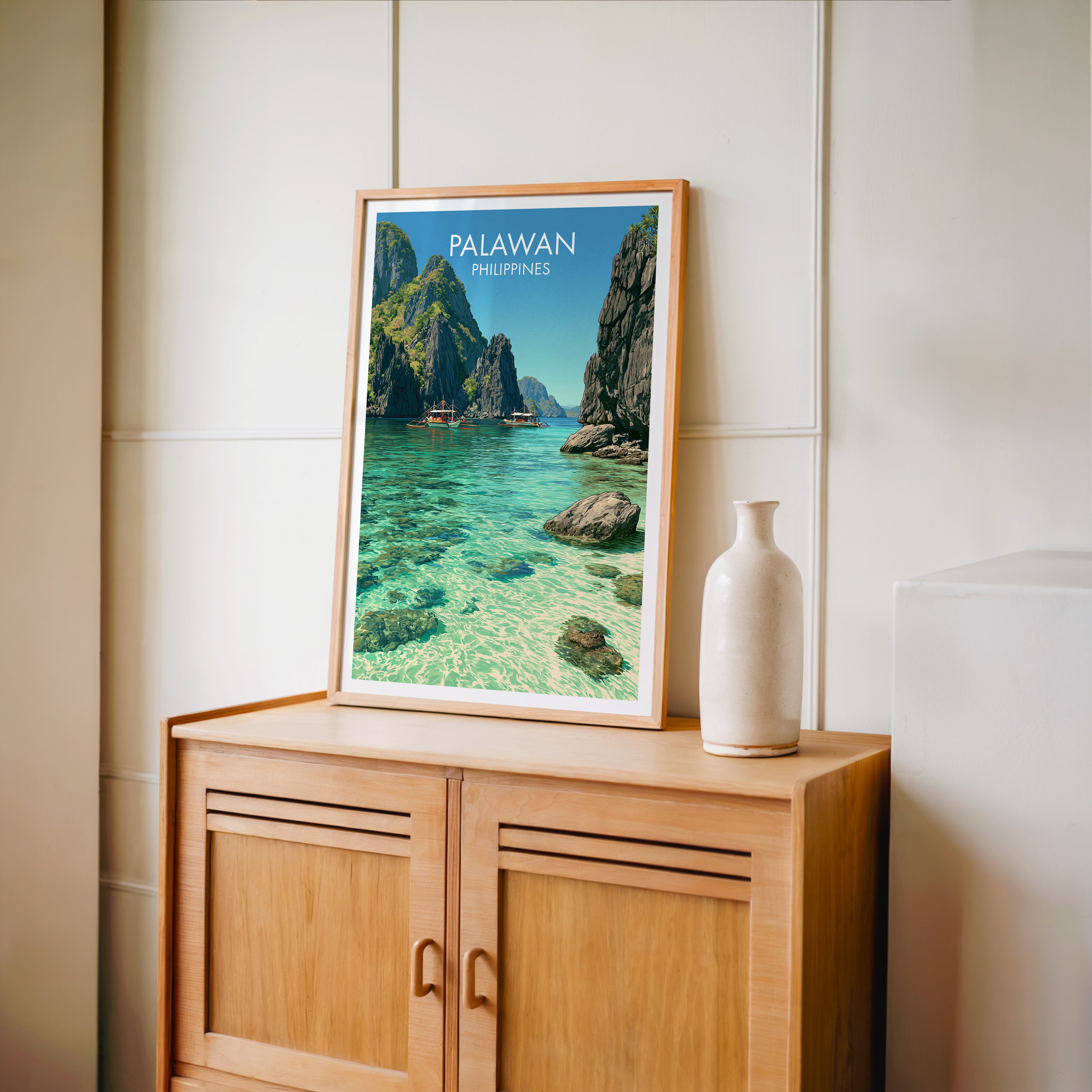 Small El Nido Palawan Philippines travel poster in an oak frame on a mid-century sideboard with a ceramic vase