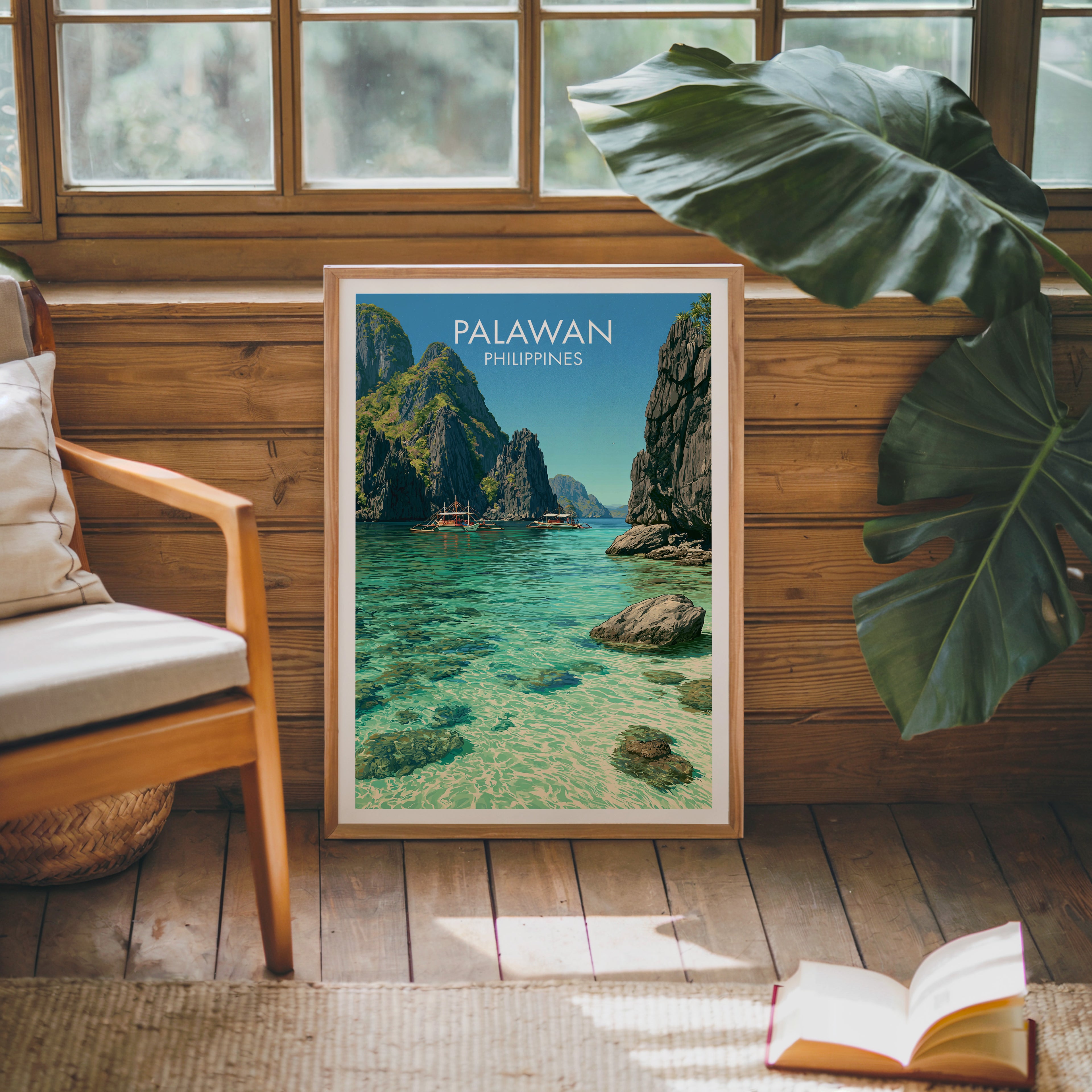 Framed El Nido Palawan Philippines poster leaning against a timber cabin wall with monstera leaves and an open book