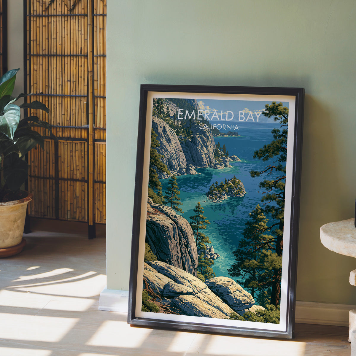 Granite cove print in a black frame by a sage green wall with a bamboo screen and a potted orchid.