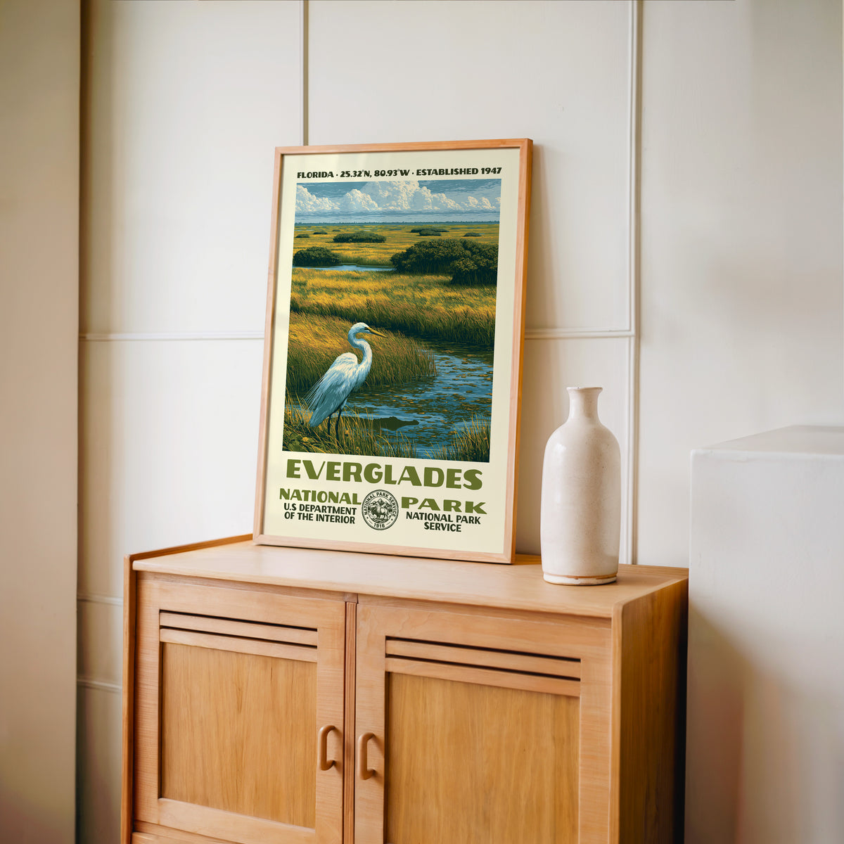 Everglades National Park WPA print framed in light oak on a wooden sideboard with a ceramic vase