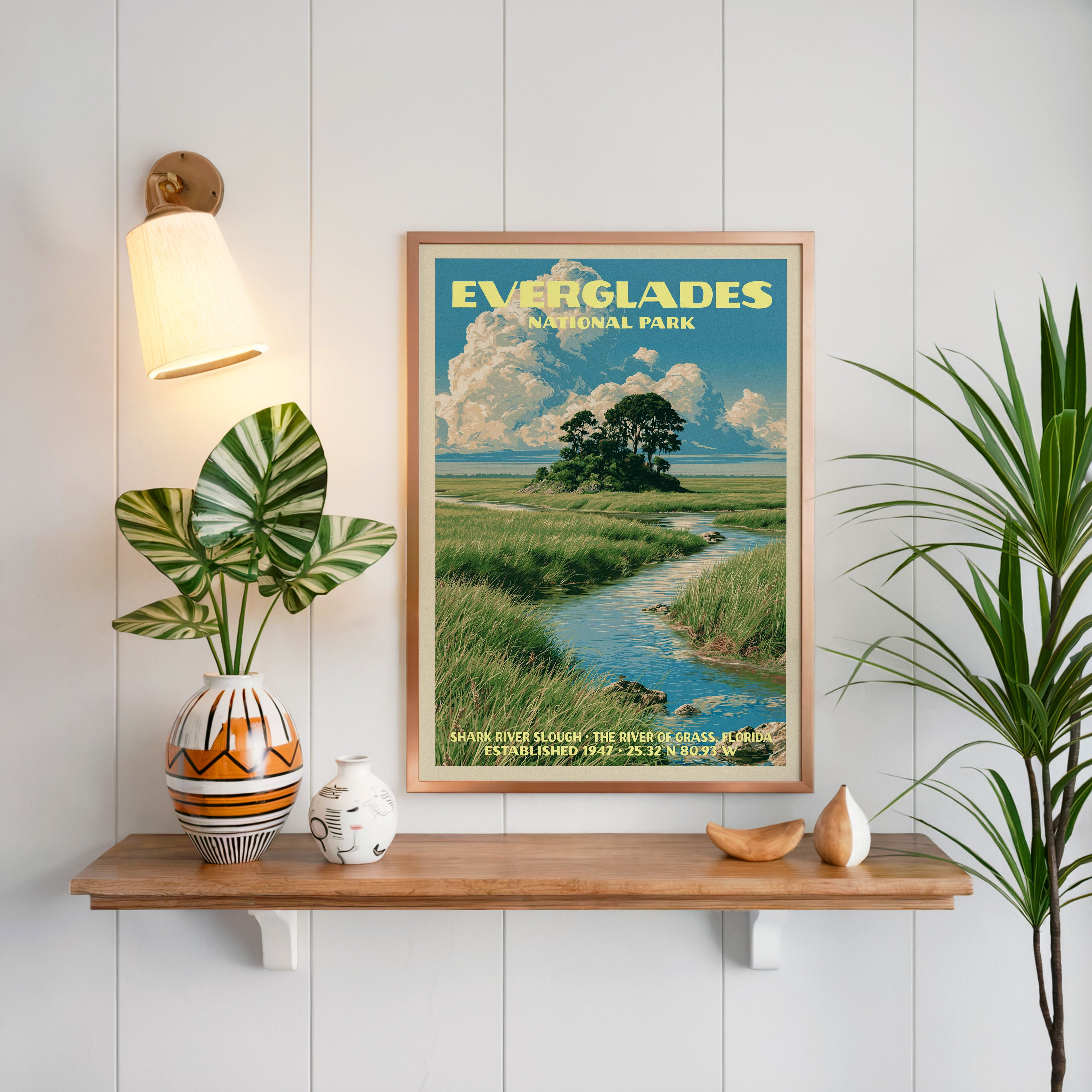 Shark River Slough Everglades print framed on white panelling above an oak shelf with a patterned vase and sconce