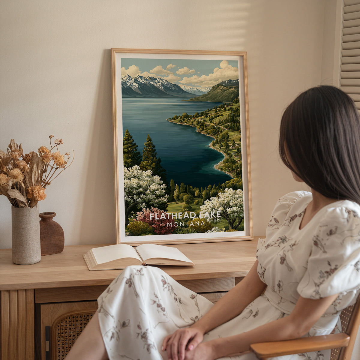 Montana travel poster on a wood sideboard with dried flowers, a woman in a white dress seated