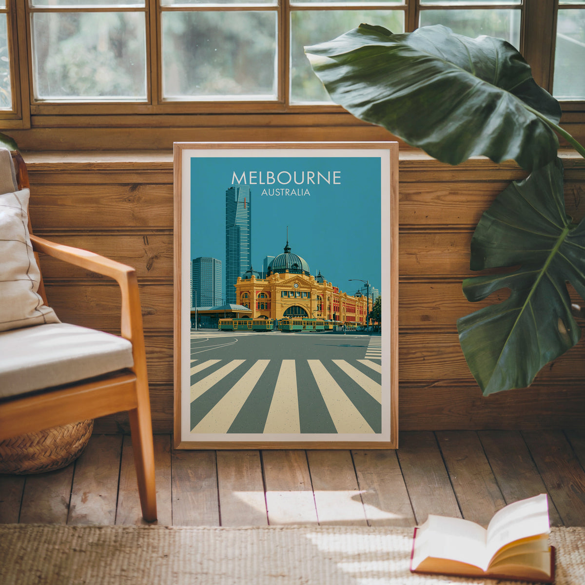 Station dome artwork in an oak frame leaning on a pine cabin wall beside a wooden armchair and jute rug