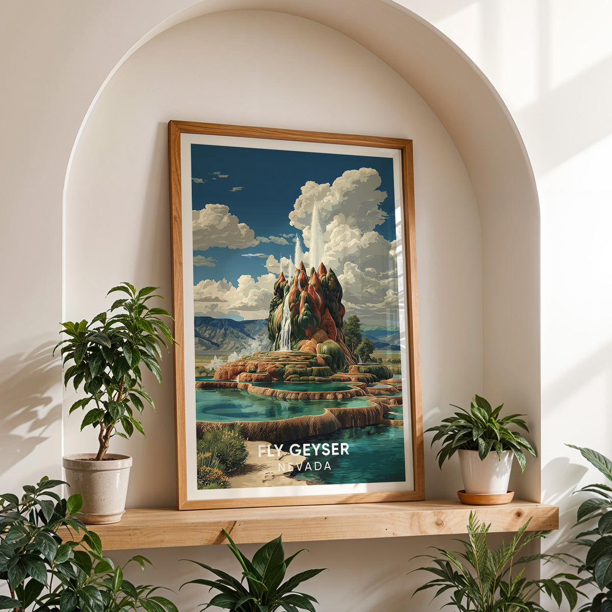 Nevada geyser poster in an oak frame on a shelf inside a white arched alcove between two potted plants.