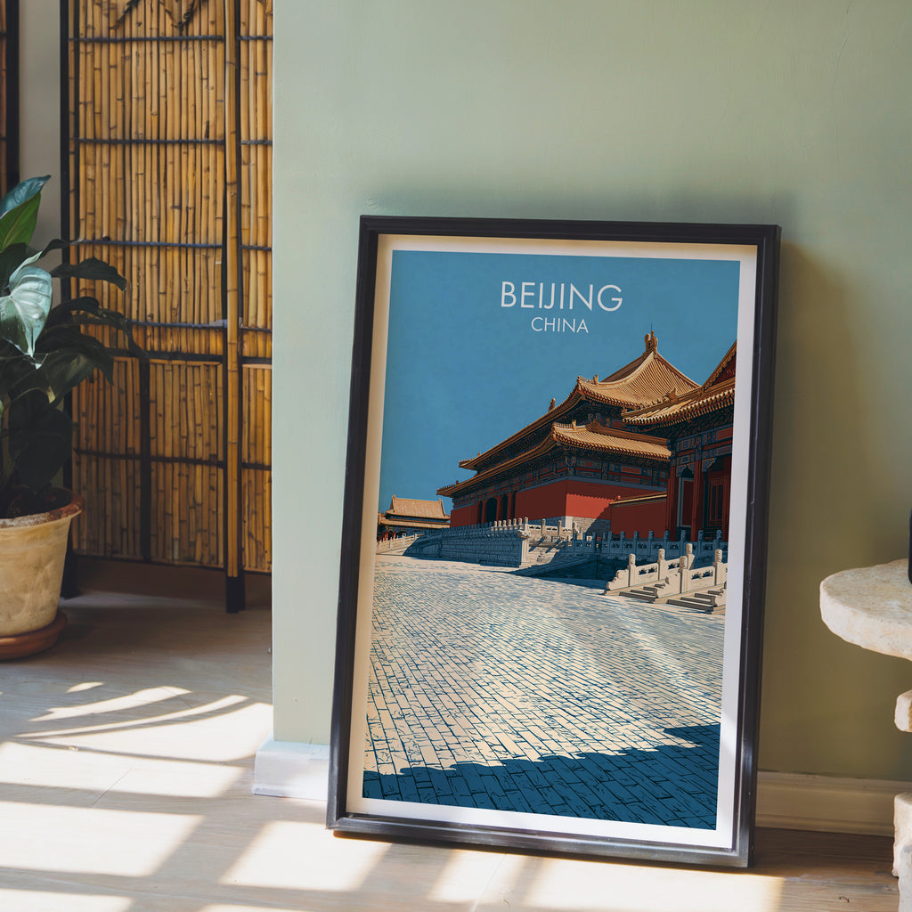 Forbidden City Beijing China wall art in a black frame leaning against a sage green wall beside a bamboo screen
