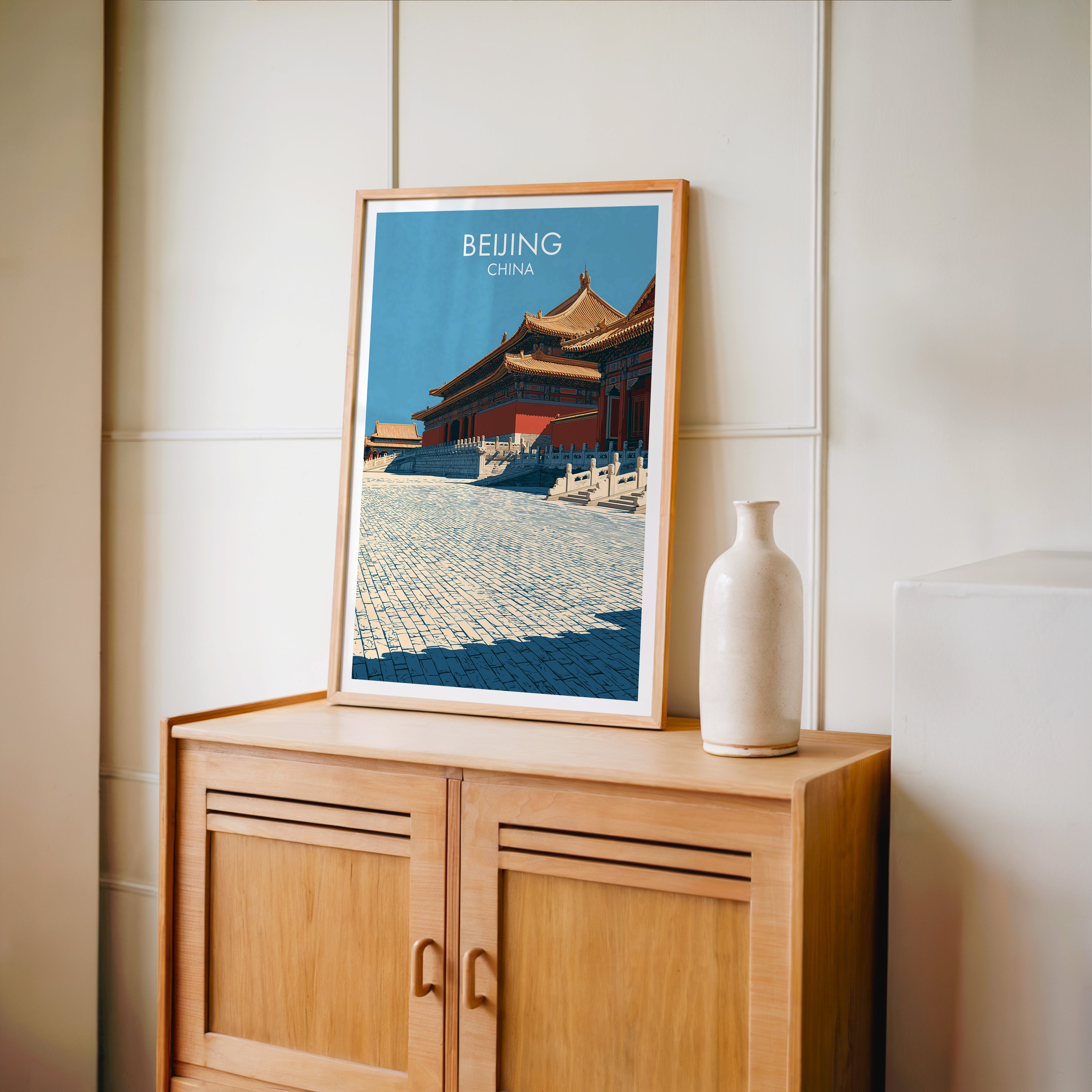 Small Forbidden City Beijing China travel poster in an oak frame on a mid-century sideboard with a ceramic vase