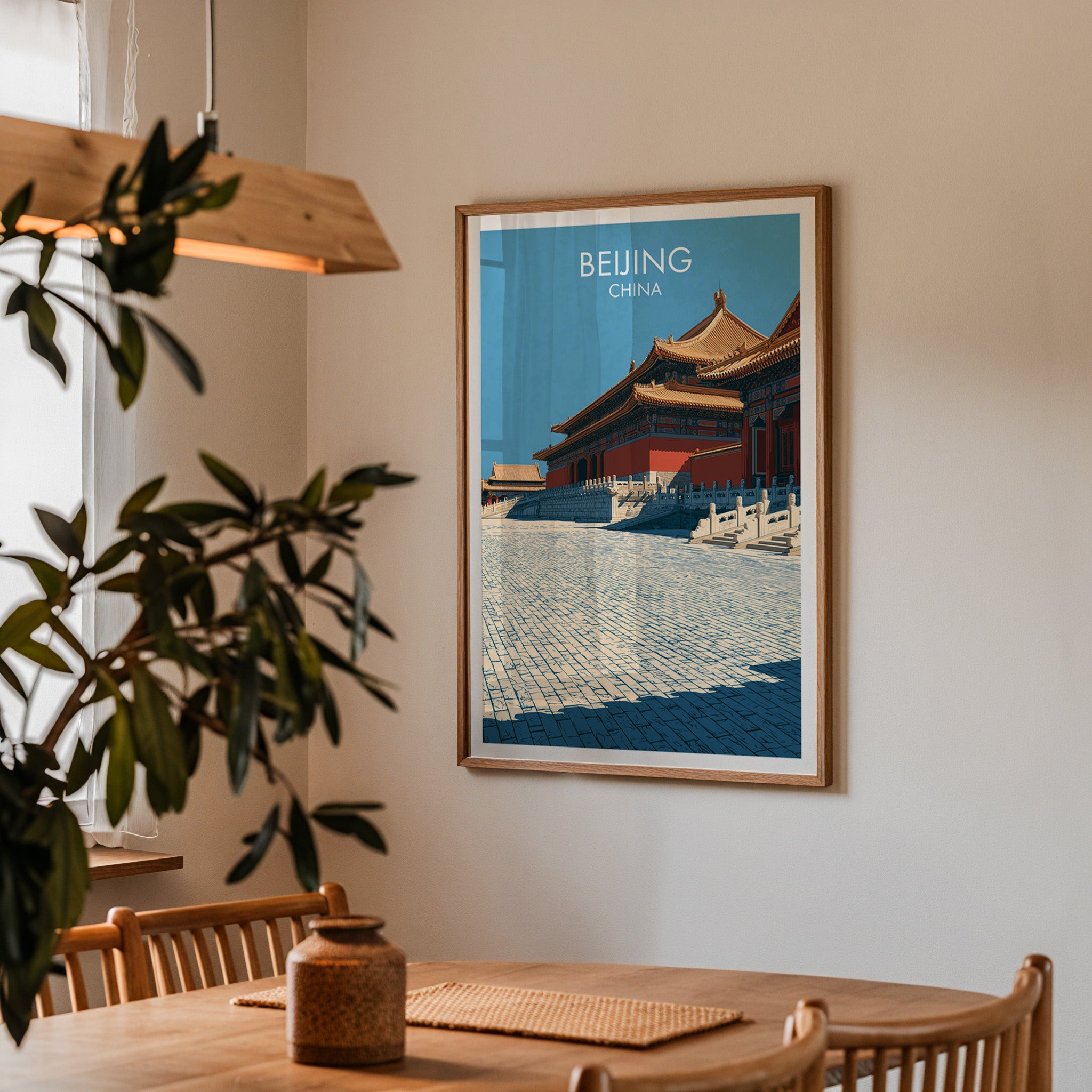 Framed Forbidden City Beijing China print on a dining room wall above an oak table in warm afternoon light