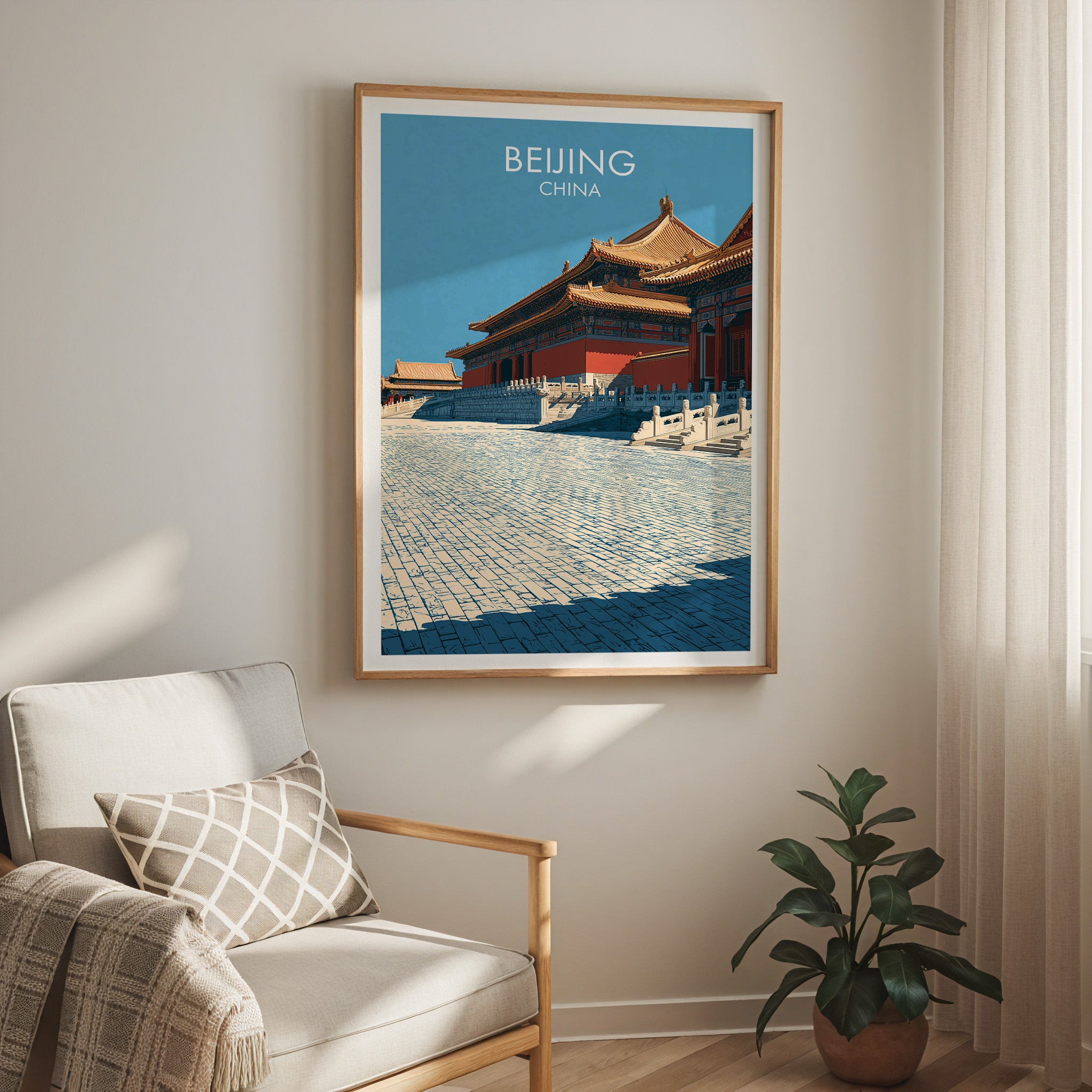 Forbidden City Beijing China travel print in a light oak frame on a living room wall beside a linen armchair