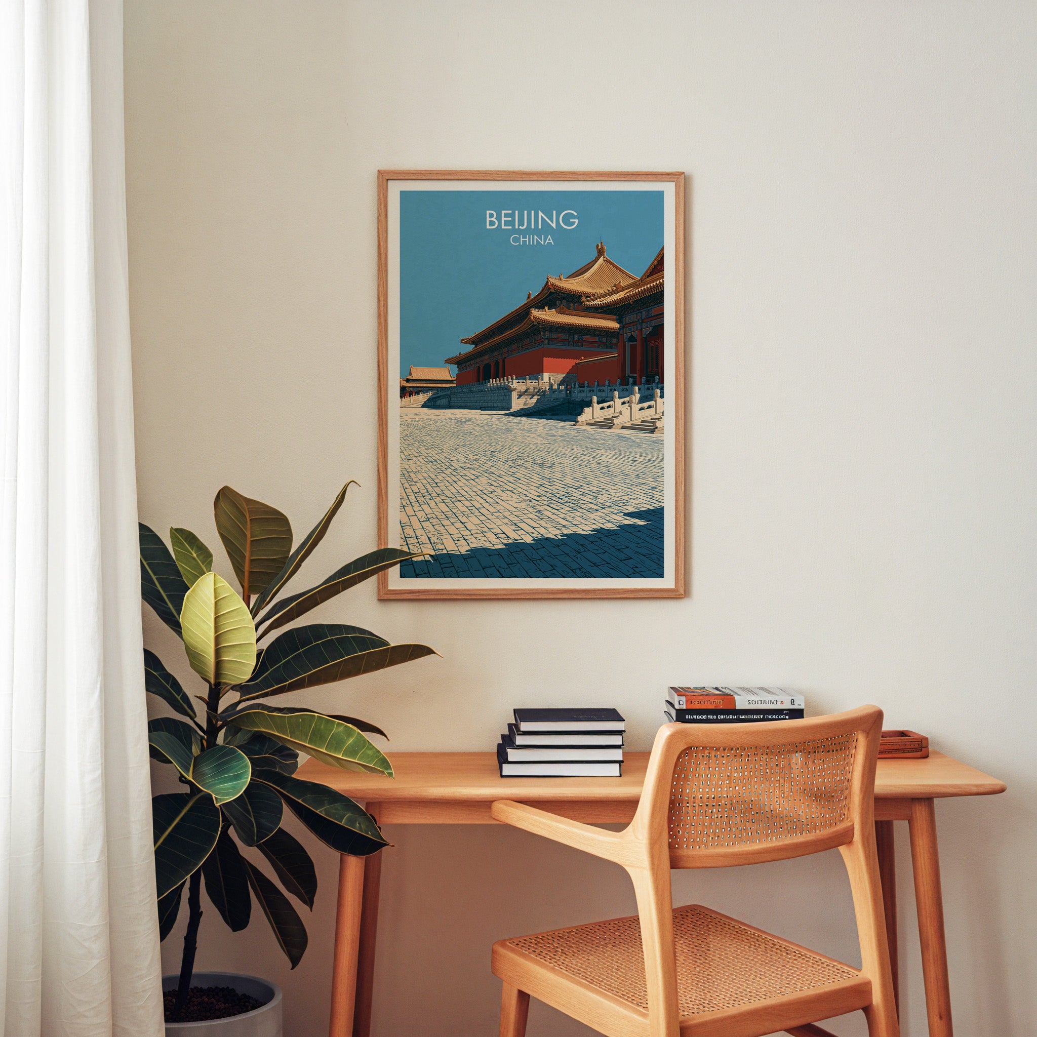 Forbidden City Beijing China wall art above a wooden home office desk with a rattan chair and books