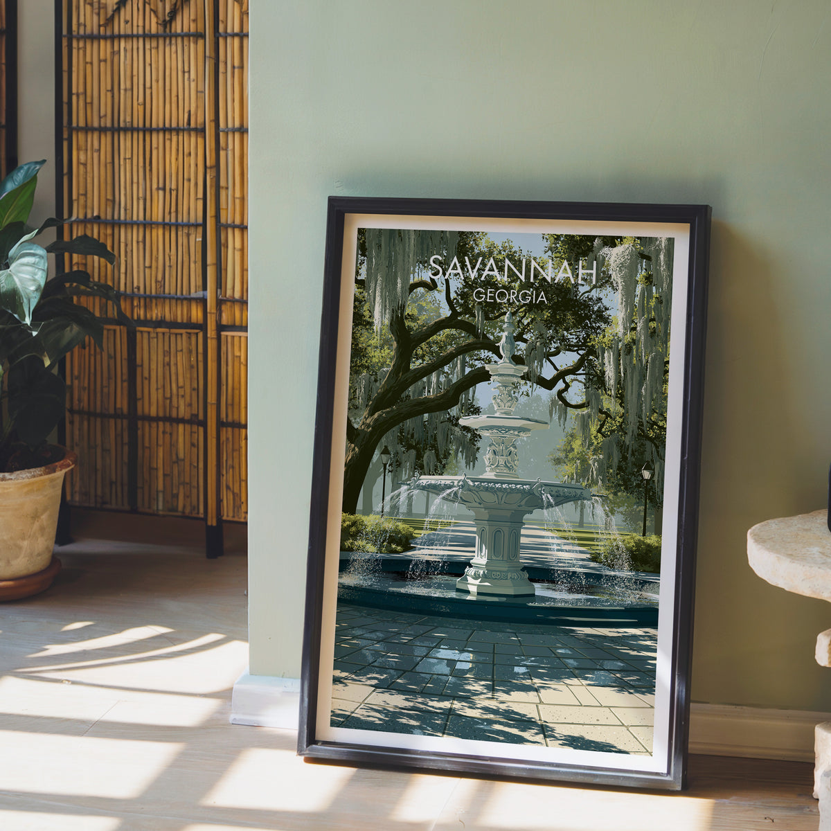 Forsyth Park Savannah print in a black frame against a sage wall with a bamboo screen and potted orchid.