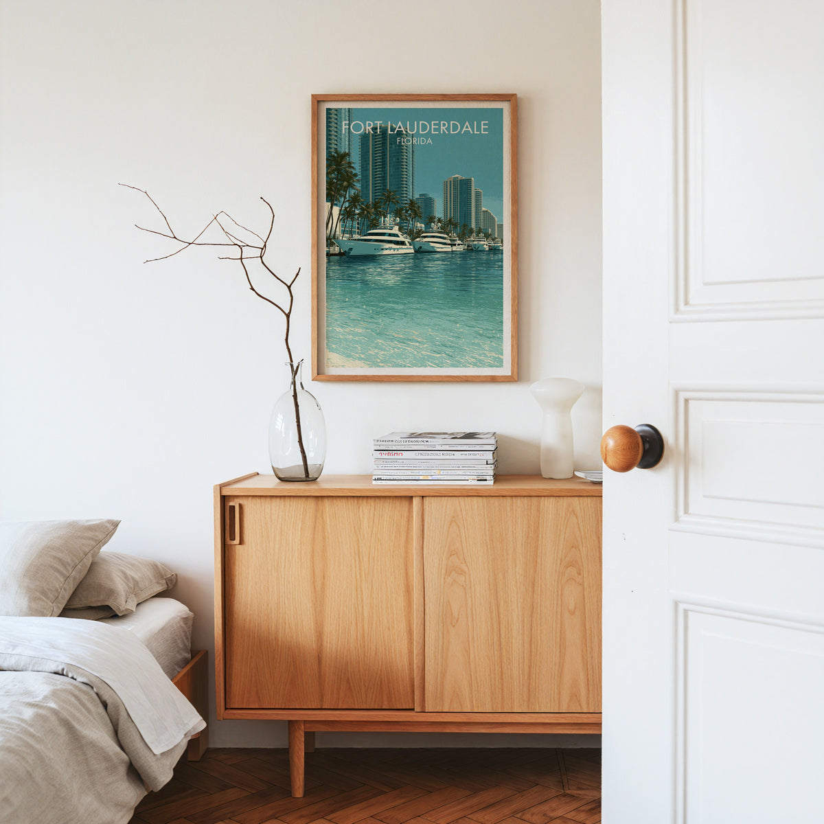 Fort Lauderdale travel poster in an oak frame on a sideboard with dried branches in glass