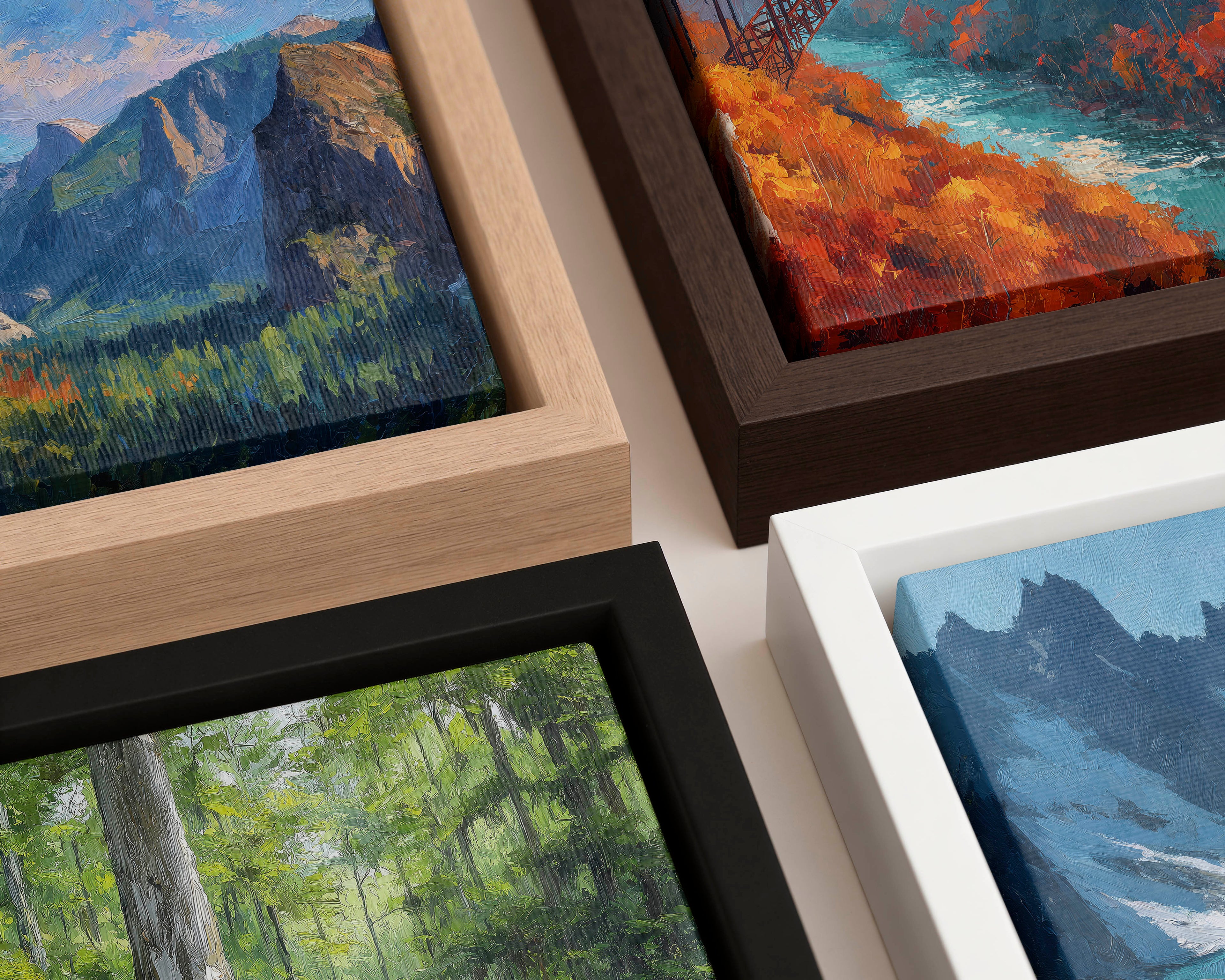 Four framed paintings of landscapes with mountains and bridges.