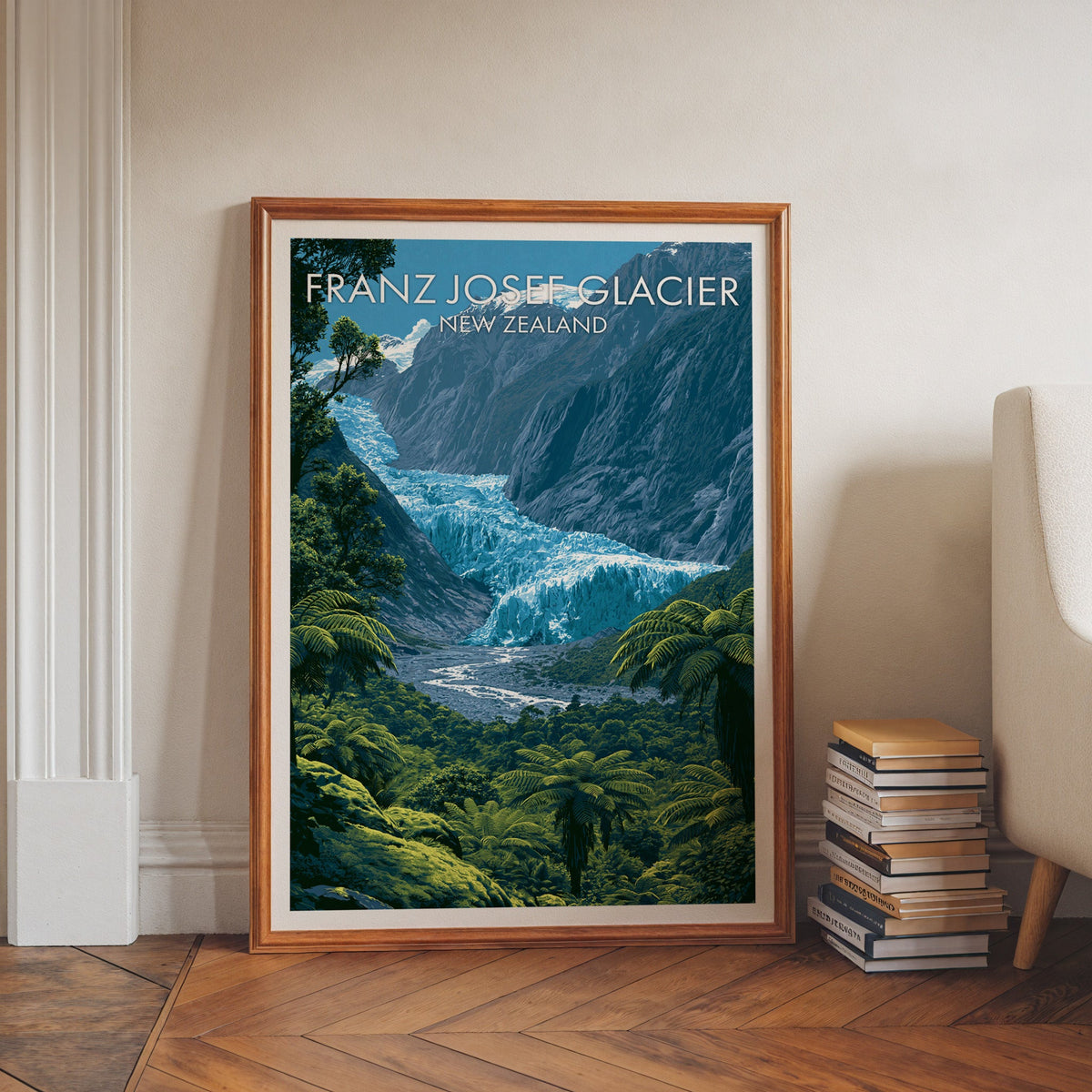 Franz Josef artwork in a walnut frame on herringbone floor beside stacked books and a pale armchair