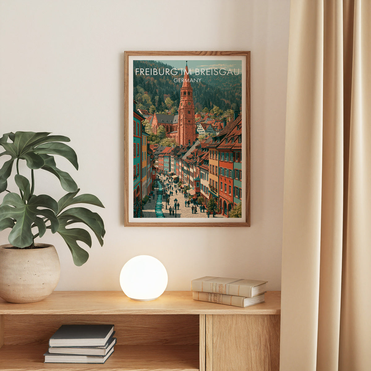 Freiburg minster tower print, oak frame above an oak console with a monstera and a round globe lamp