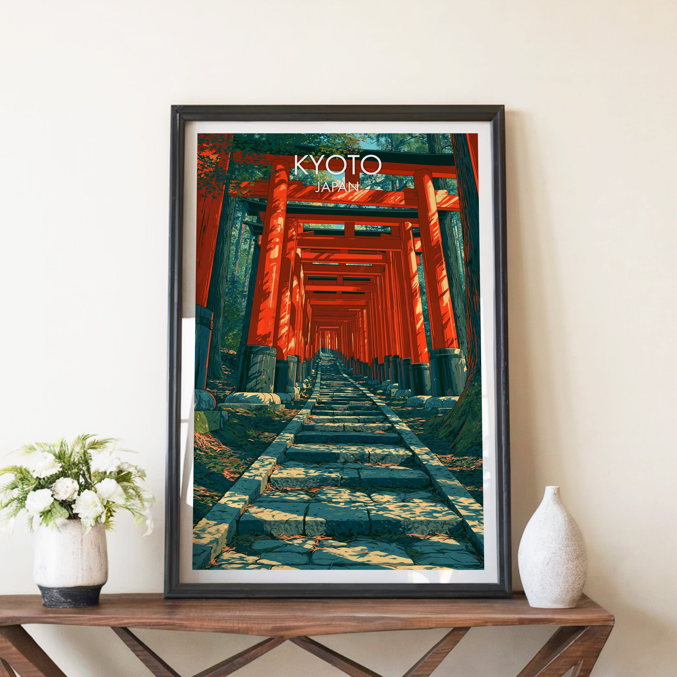 Fushimi Inari Kyoto Japan travel poster in a black frame on a wooden console table with white flowers
