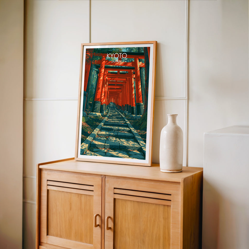 Small Fushimi Inari Kyoto Japan travel poster in an oak frame on a mid-century sideboard with a ceramic vase