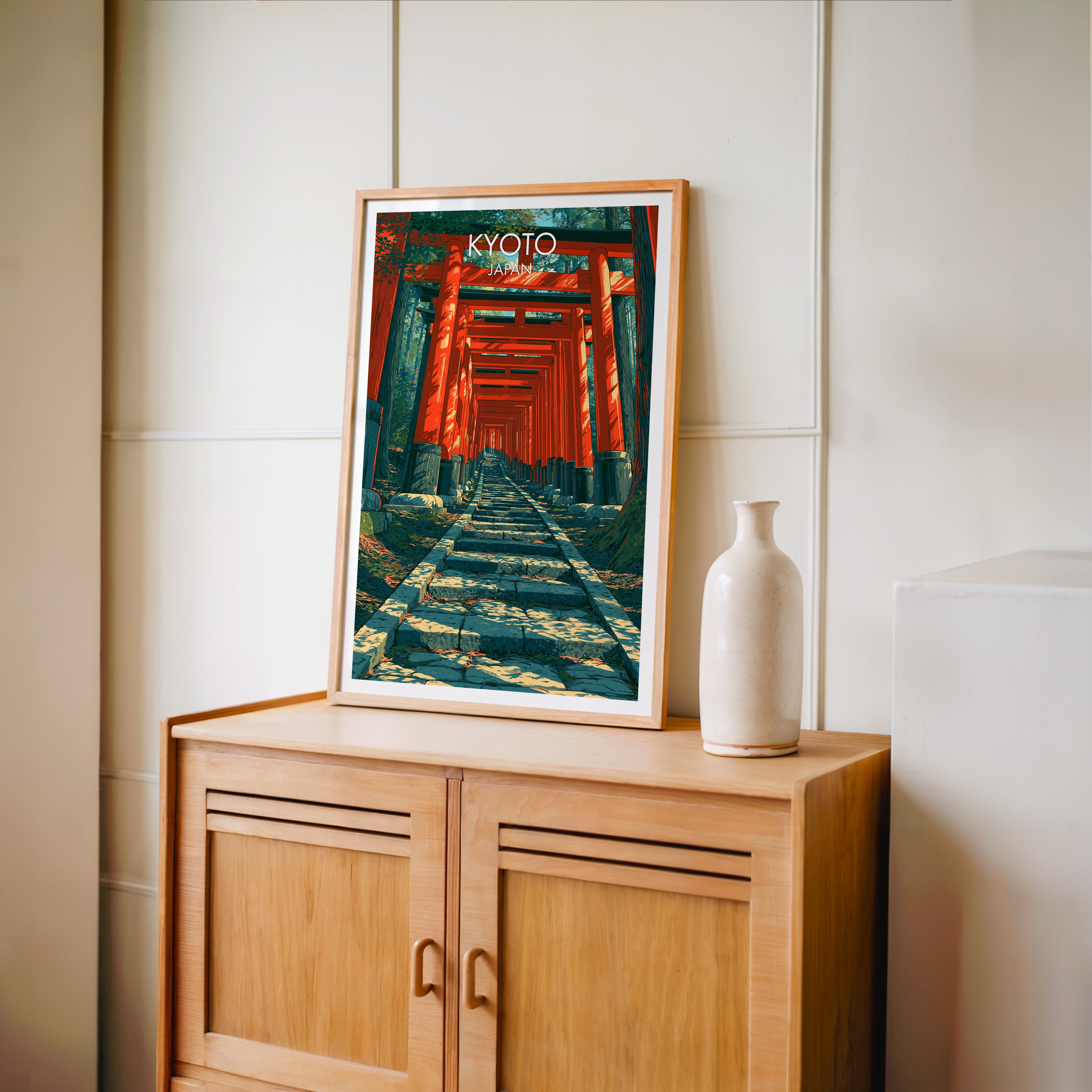 Small Fushimi Inari Kyoto Japan travel poster in an oak frame on a mid-century sideboard with a ceramic vase