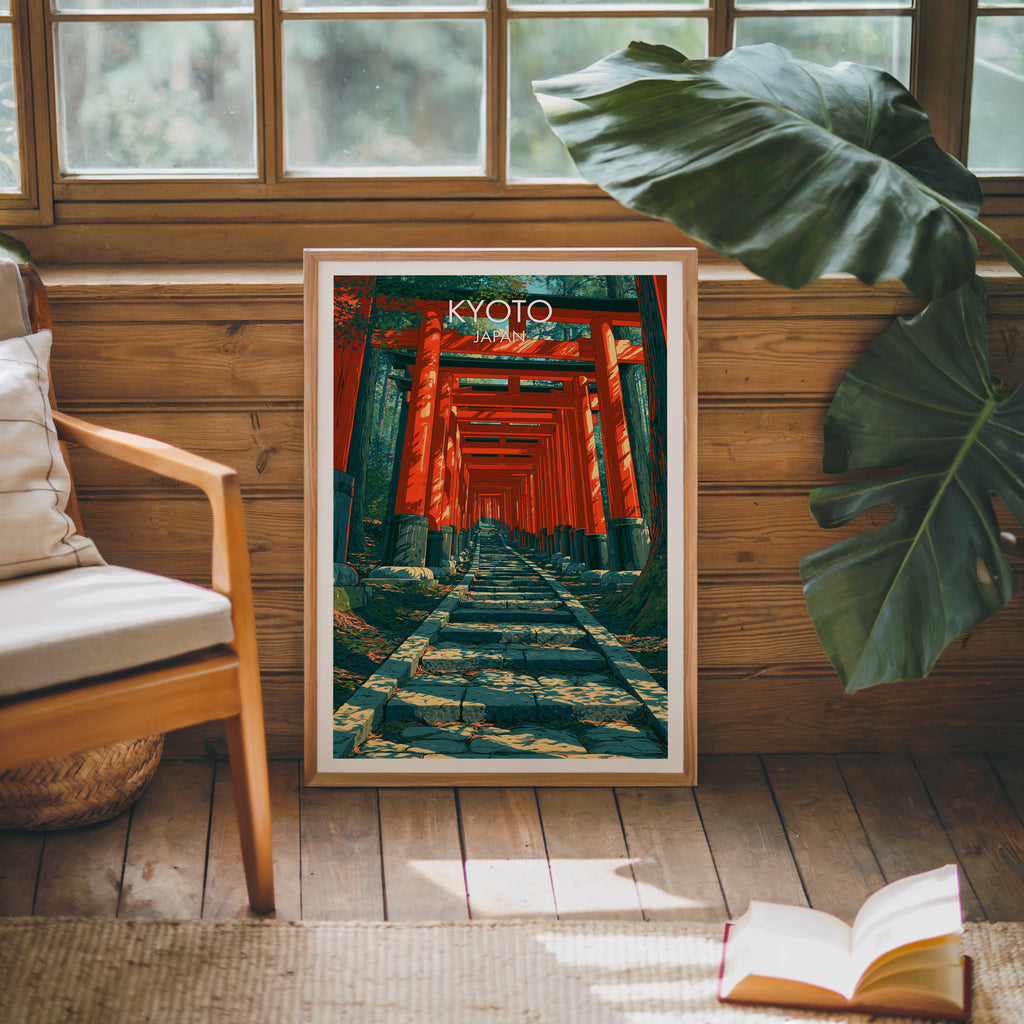 Framed Fushimi Inari Kyoto Japan poster leaning against a timber cabin wall with monstera leaves and an open book