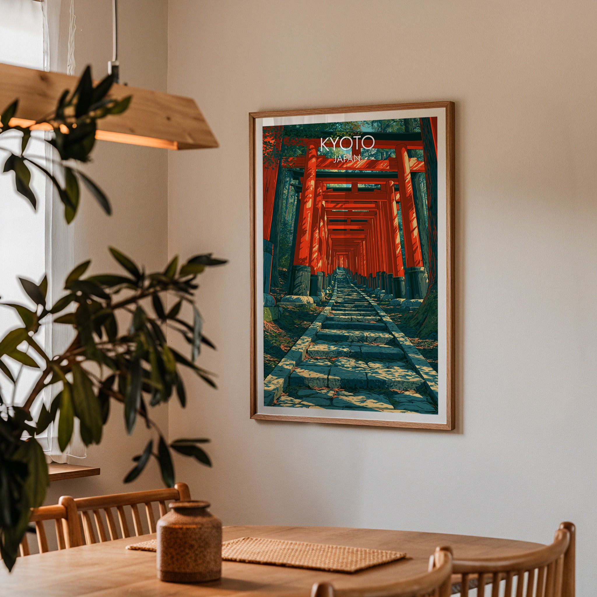 Framed Fushimi Inari Kyoto Japan print on a dining room wall above an oak table in warm afternoon light