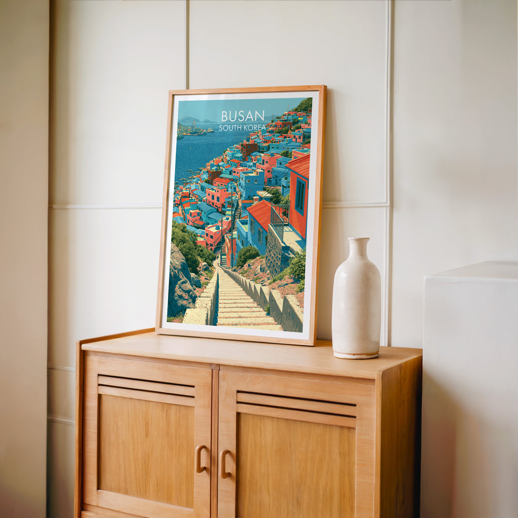 Small Gamcheon Culture Village Busan travel poster in an oak frame on a mid-century sideboard with a ceramic vase