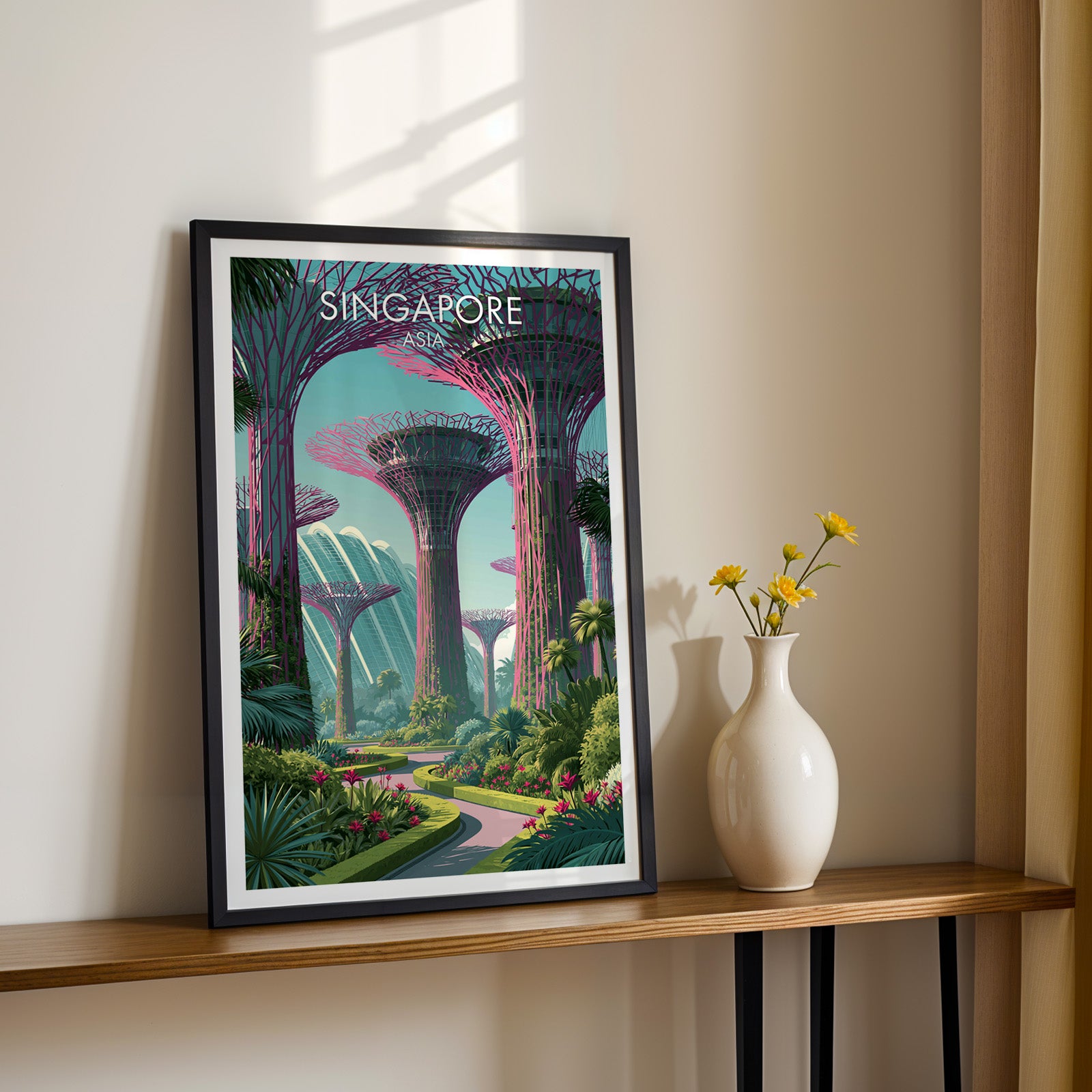 Black framed Gardens by the Bay Singapore print on a narrow hallway console in sunlight, styled with yellow flowers