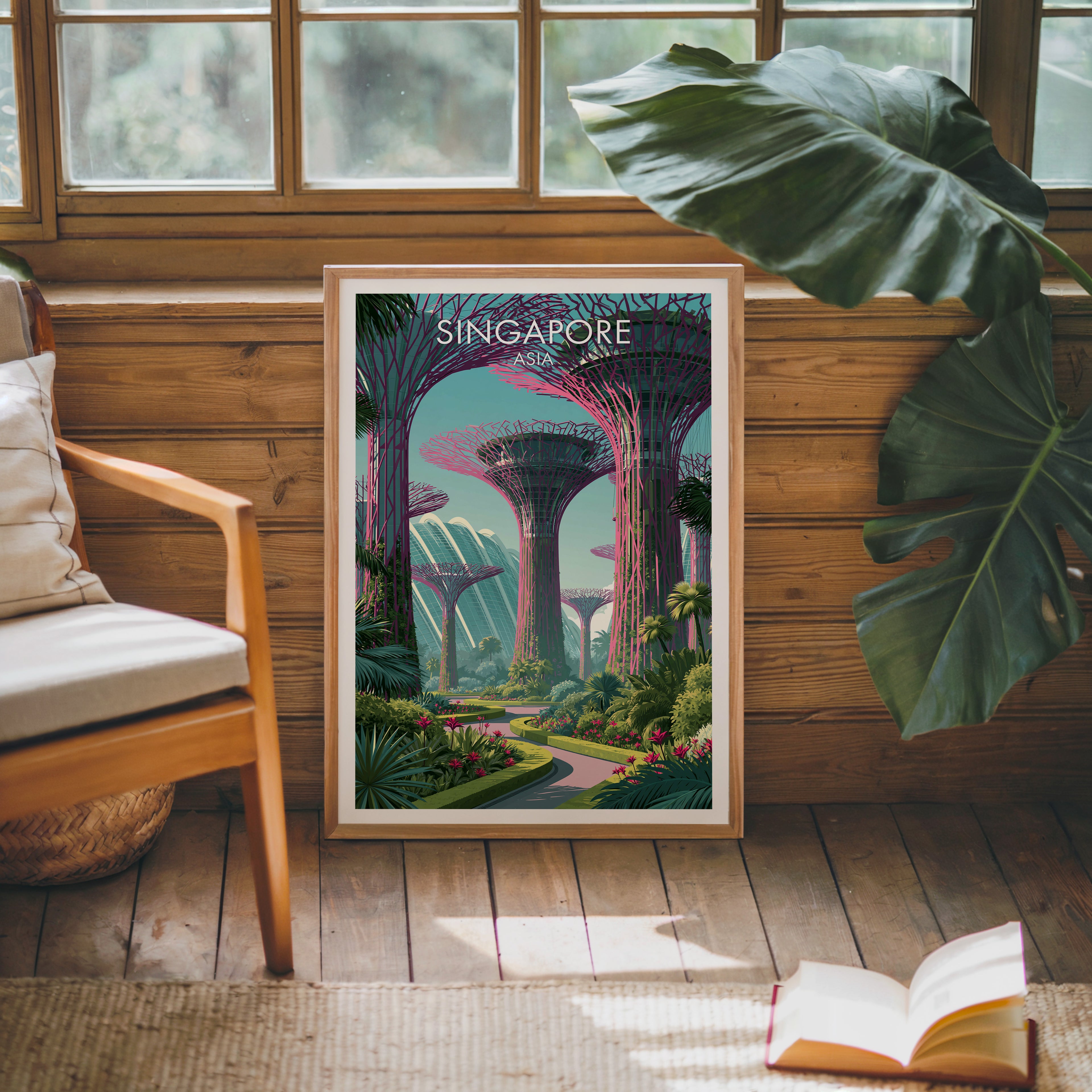 Framed Gardens by the Bay Singapore poster leaning against a timber cabin wall with monstera leaves and an open book