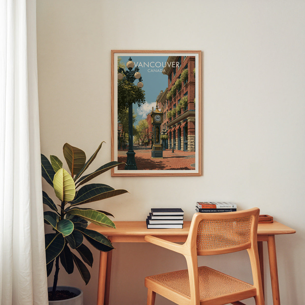 Vancouver steam clock travel print in an oak frame above a wood desk with a cane chair
