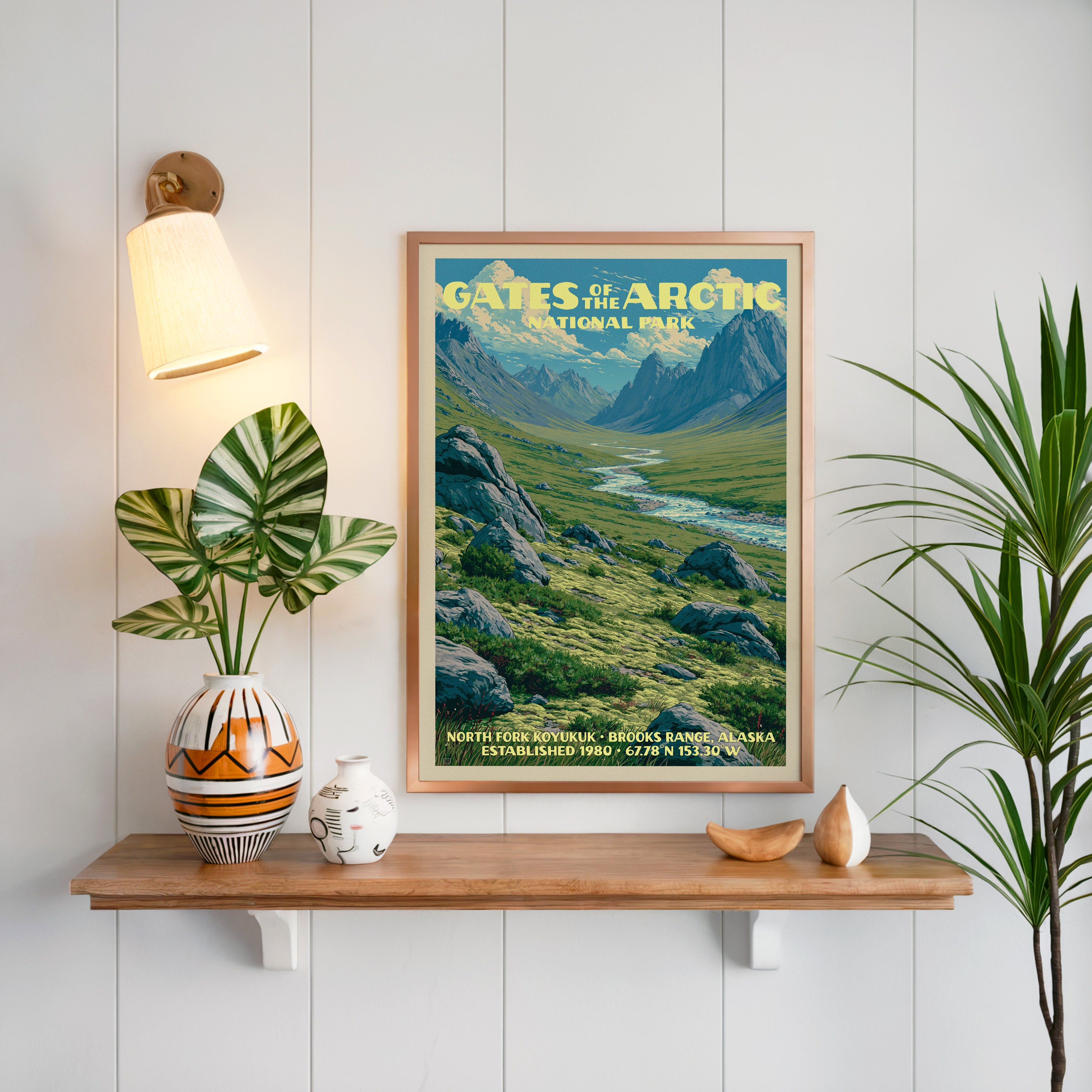 North Fork Koyukuk print framed on white panelling above an oak shelf with a patterned vase and brass sconce