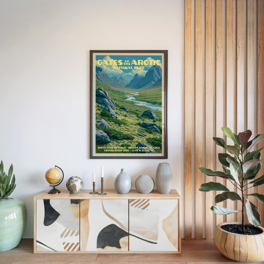 Gates of the Arctic National Park poster in a black frame above a light wood sideboard by a slatted panel