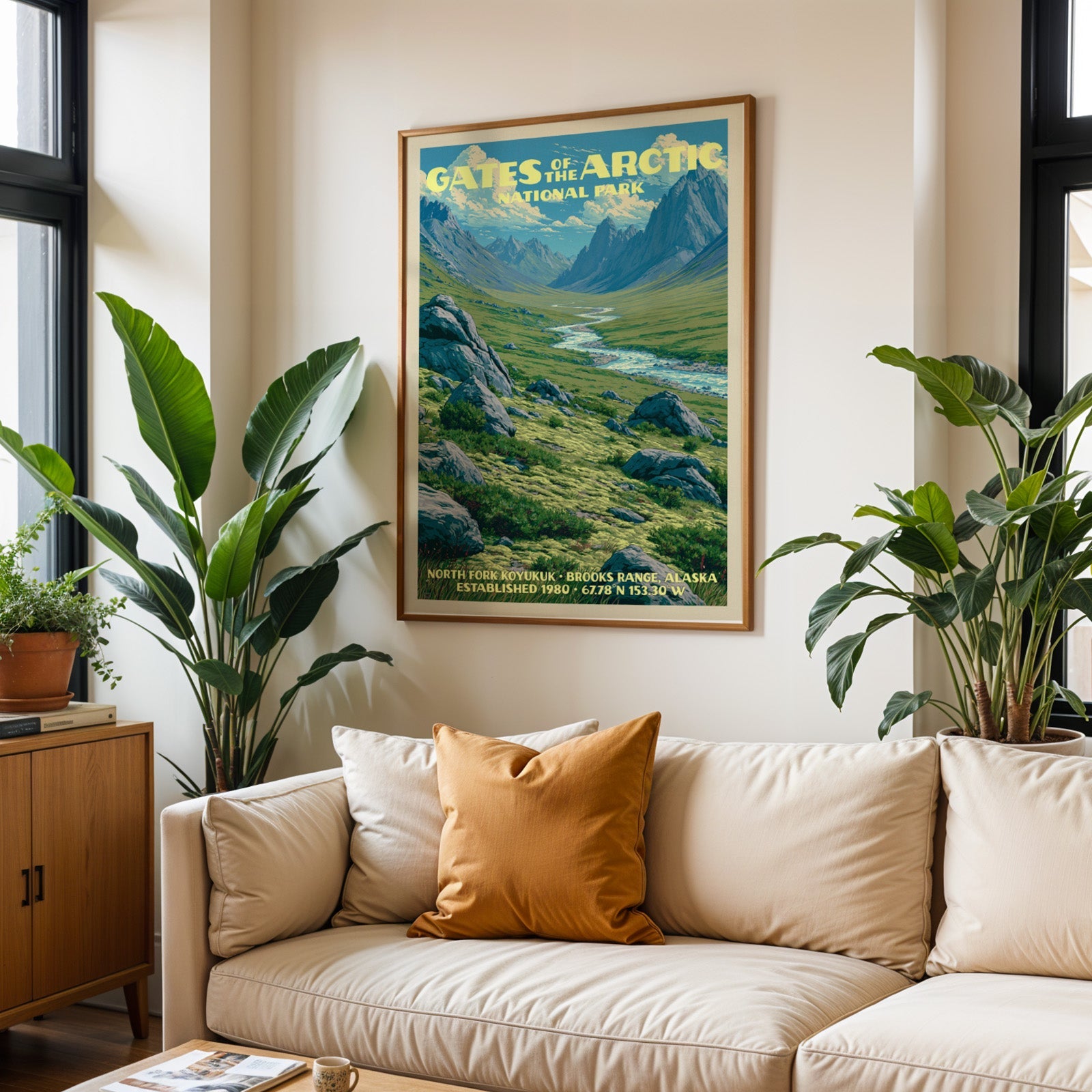 Gates of the Arctic vintage travel print in oak above a cream sofa with a rust cushion and tall plants