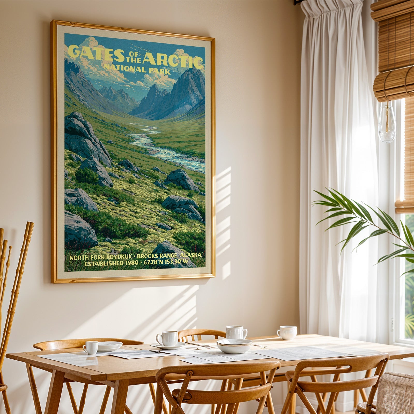 Gates of the Arctic National Park print in gold above a light oak dining table by a curtained window