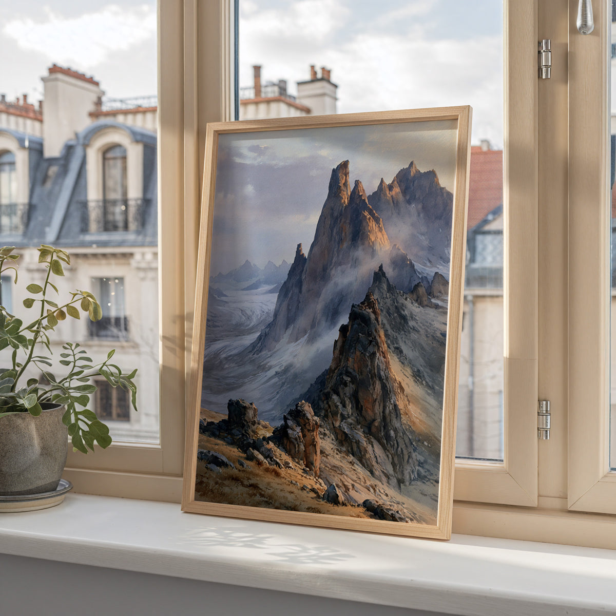 Gates of the Arctic watercolor art print in a wood frame on a windowsill overlooking city rooftops