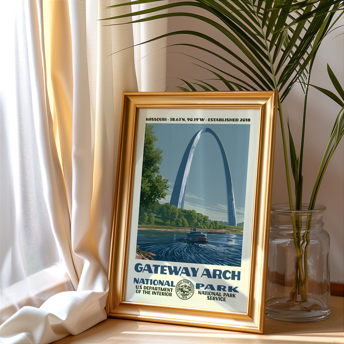 Gateway Arch National Park vintage poster in a gold frame beside a linen curtain and potted palm