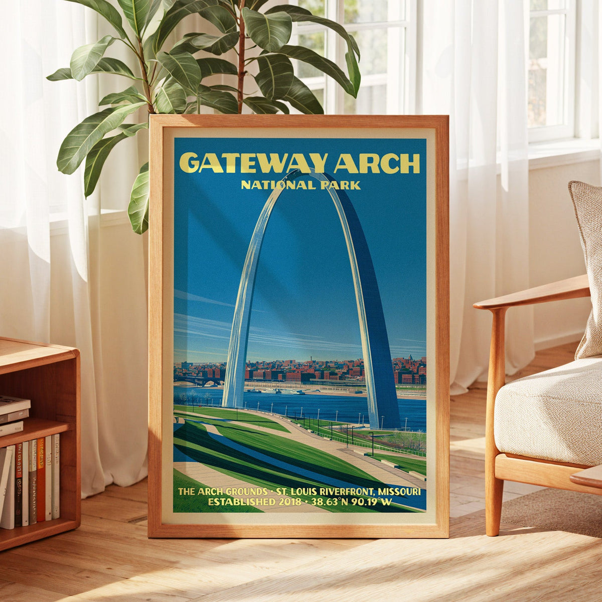 Gateway Arch vintage poster in oak, leaning by a sunlit window with sheer curtains and a low bookshelf