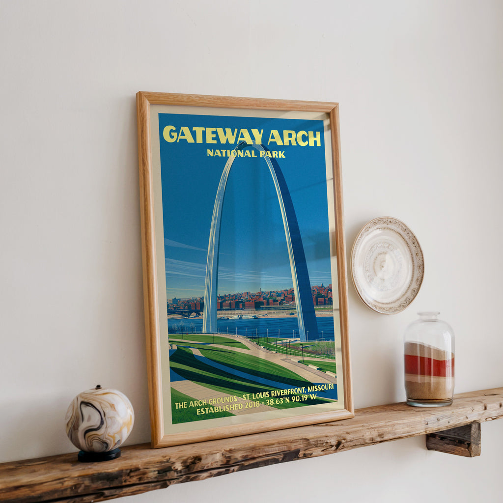 Gateway Arch print in oak, leaning on a reclaimed wood ledge with a marbled stone sphere and sand jar