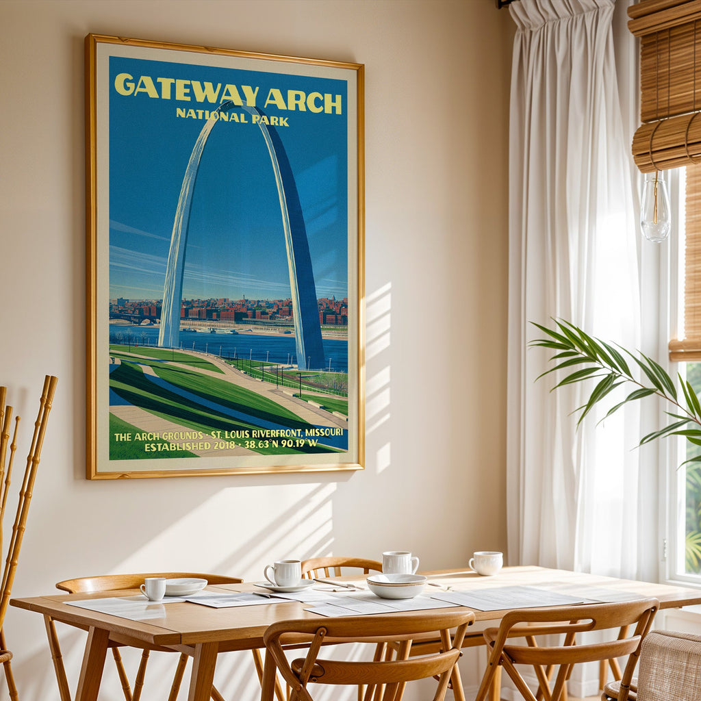 Gateway Arch National Park print in gold above a light oak dining table by a sheer-curtained window