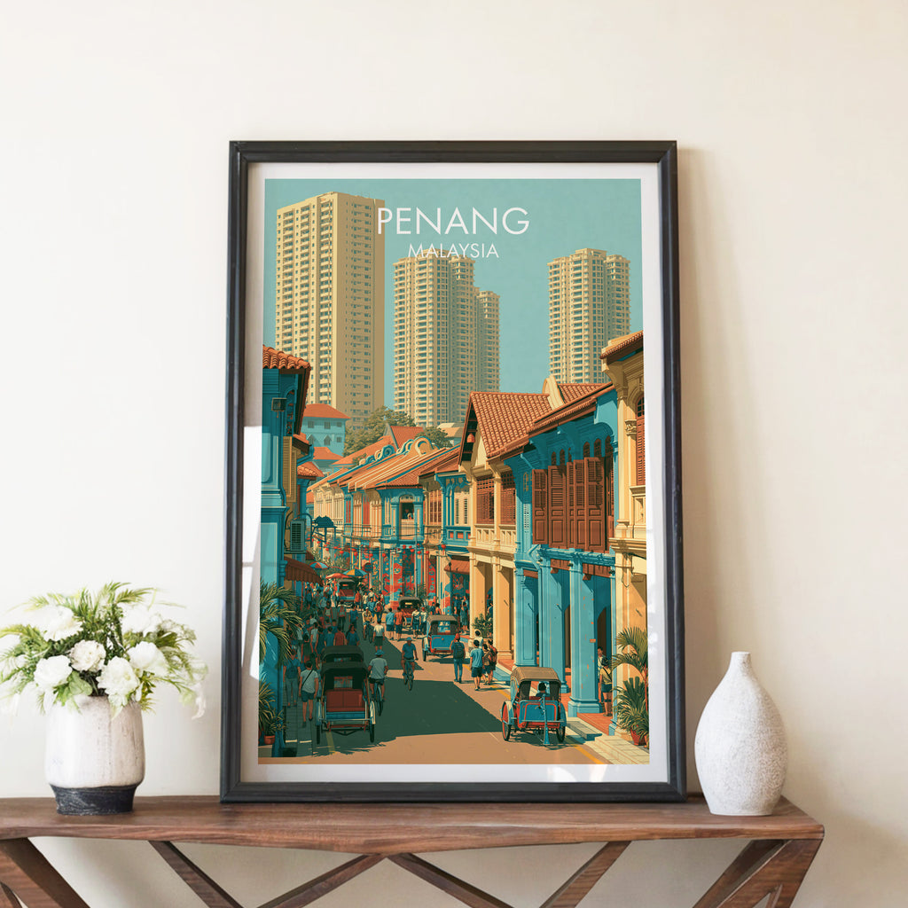 Georgetown Penang Malaysia travel poster in a black frame on a wooden console table with white flowers