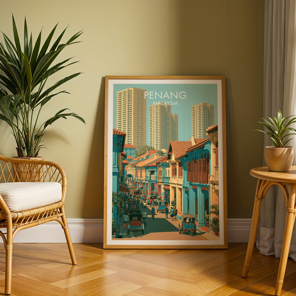 Large Georgetown Penang Malaysia travel print in an oak frame leaning on a herringbone floor next to a rattan chair