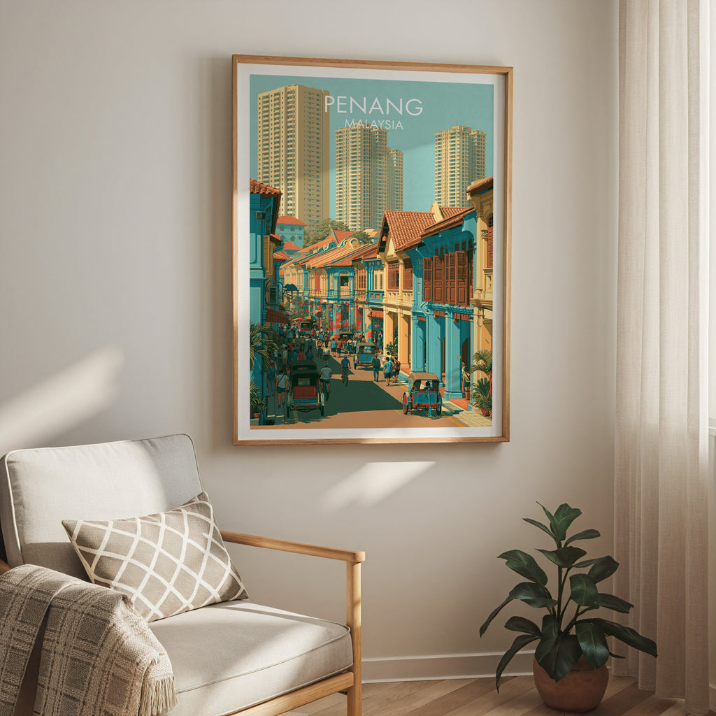 Georgetown Penang Malaysia travel print in a light oak frame on a living room wall beside a linen armchair