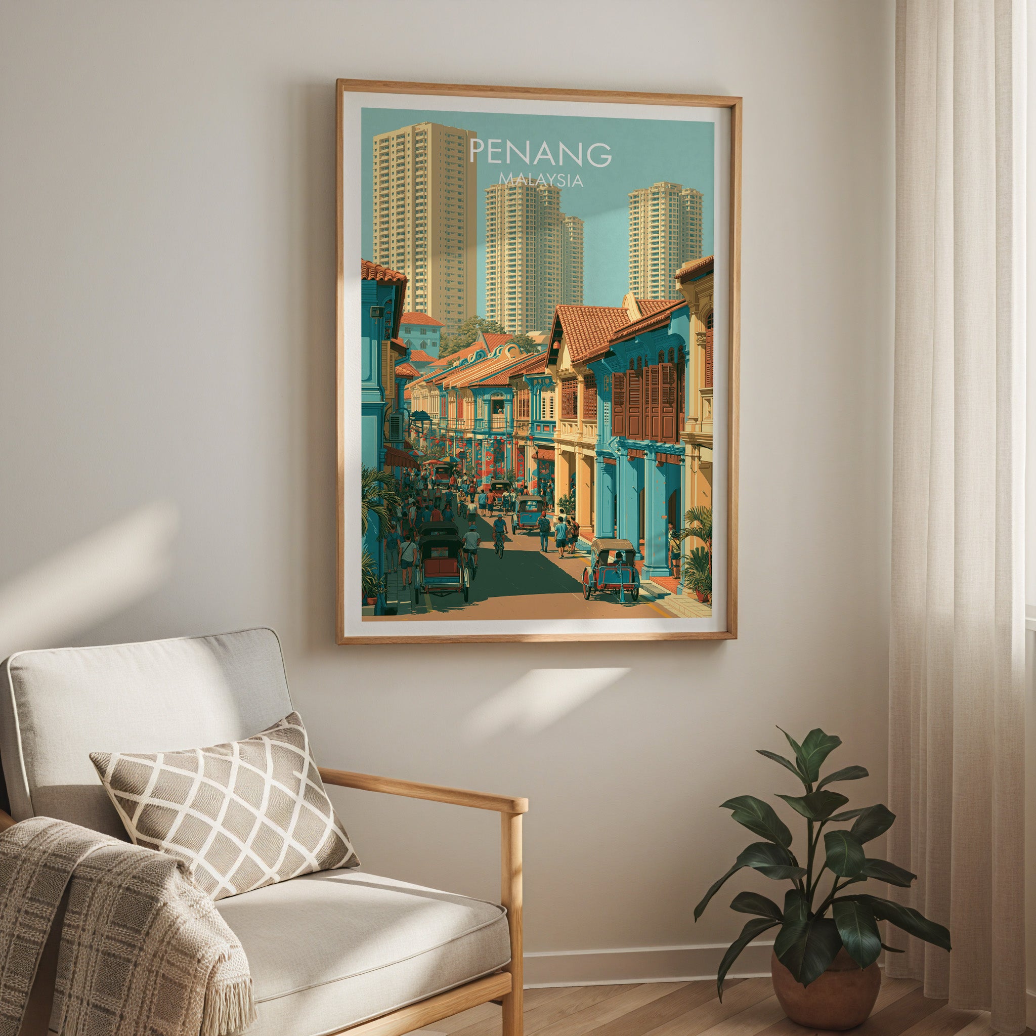Georgetown Penang Malaysia travel print in a light oak frame on a living room wall beside a linen armchair
