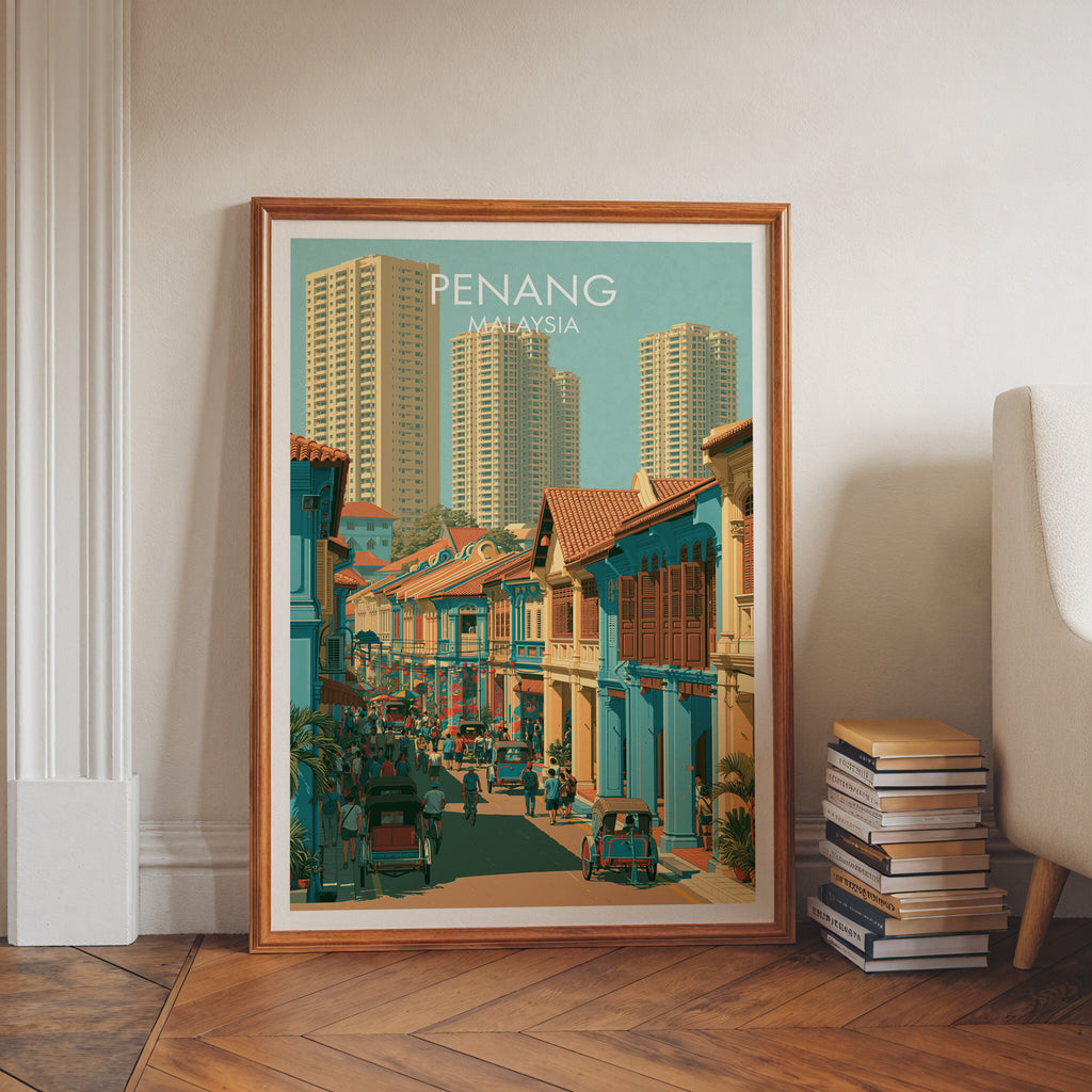 Georgetown Penang Malaysia art print in a walnut frame leaning in a hallway beside stacked books