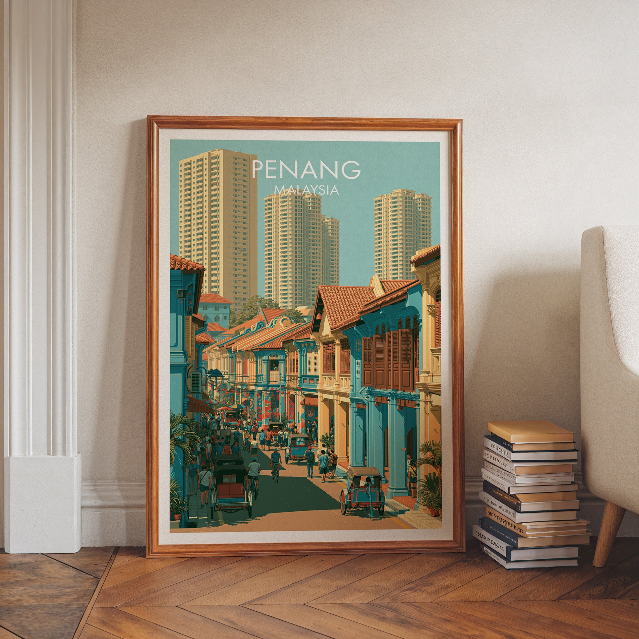 Georgetown Penang Malaysia art print in a walnut frame leaning in a hallway beside stacked books