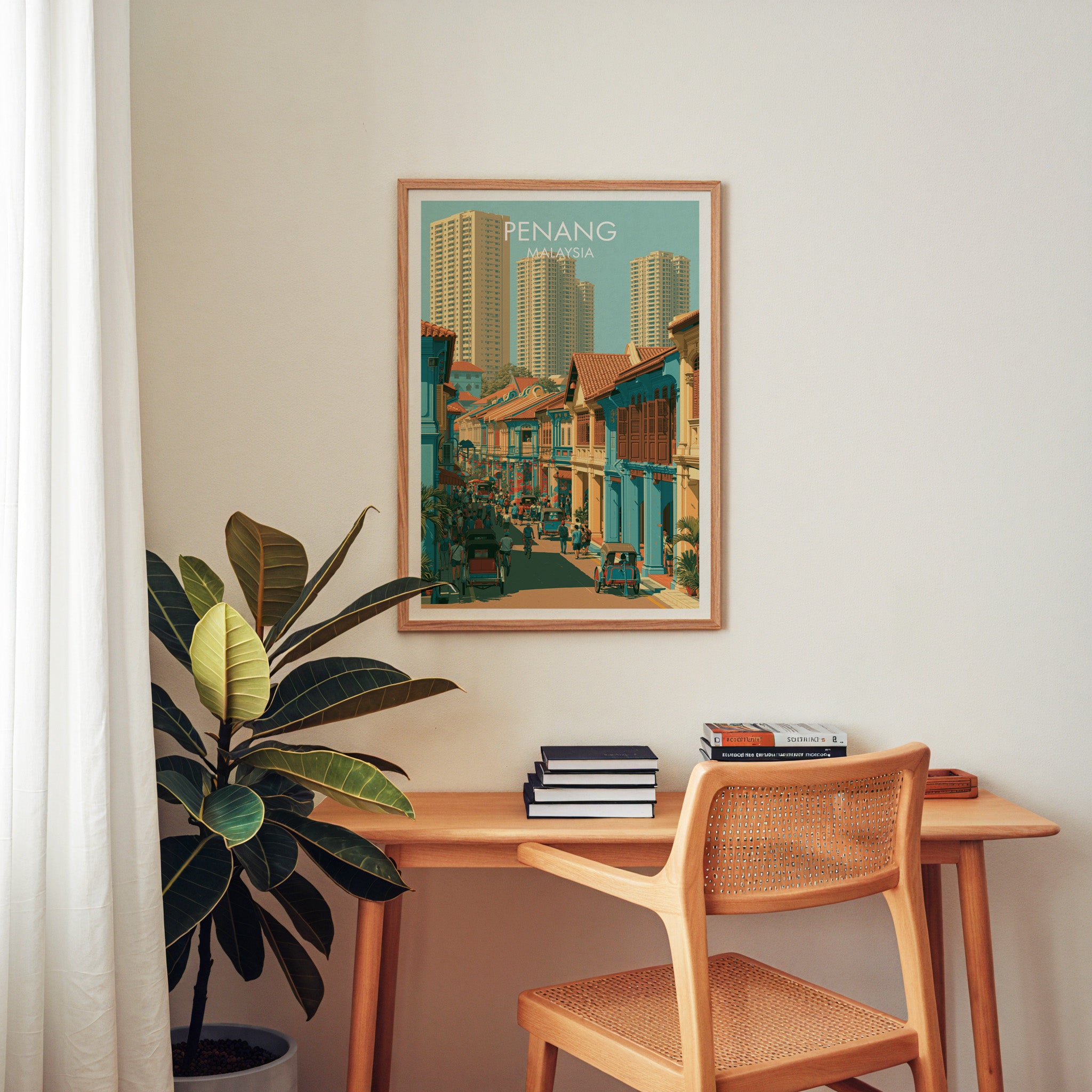Georgetown Penang Malaysia wall art above a wooden home office desk with a rattan chair and books