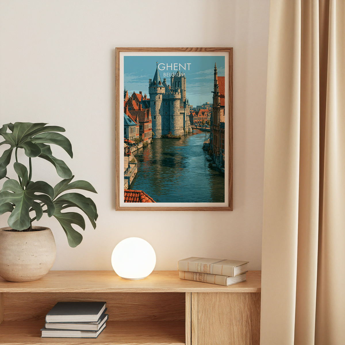 Gravensteen Ghent print, oak frame above an oak console with a monstera and a round globe lamp
