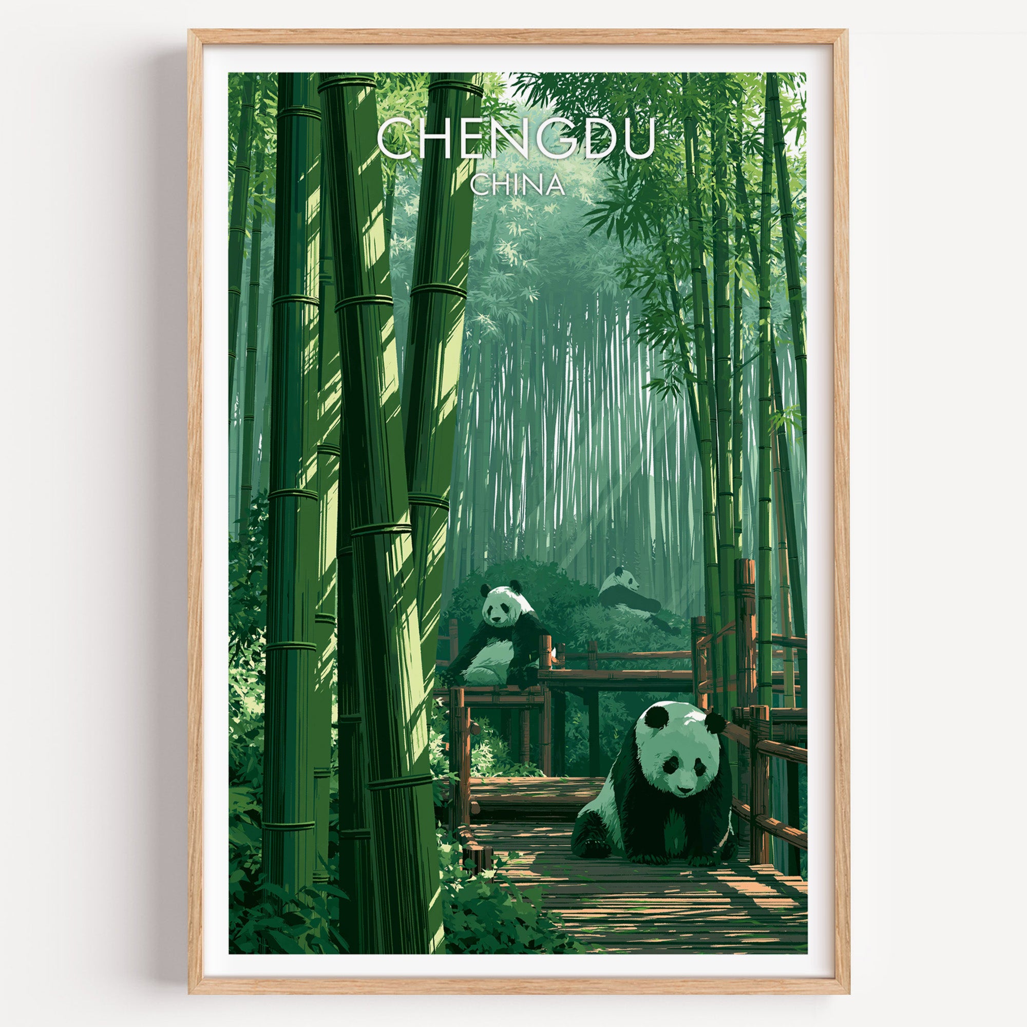 Giant Pandas Chengdu China travel poster in a natural wood frame, shown against a clean white wall