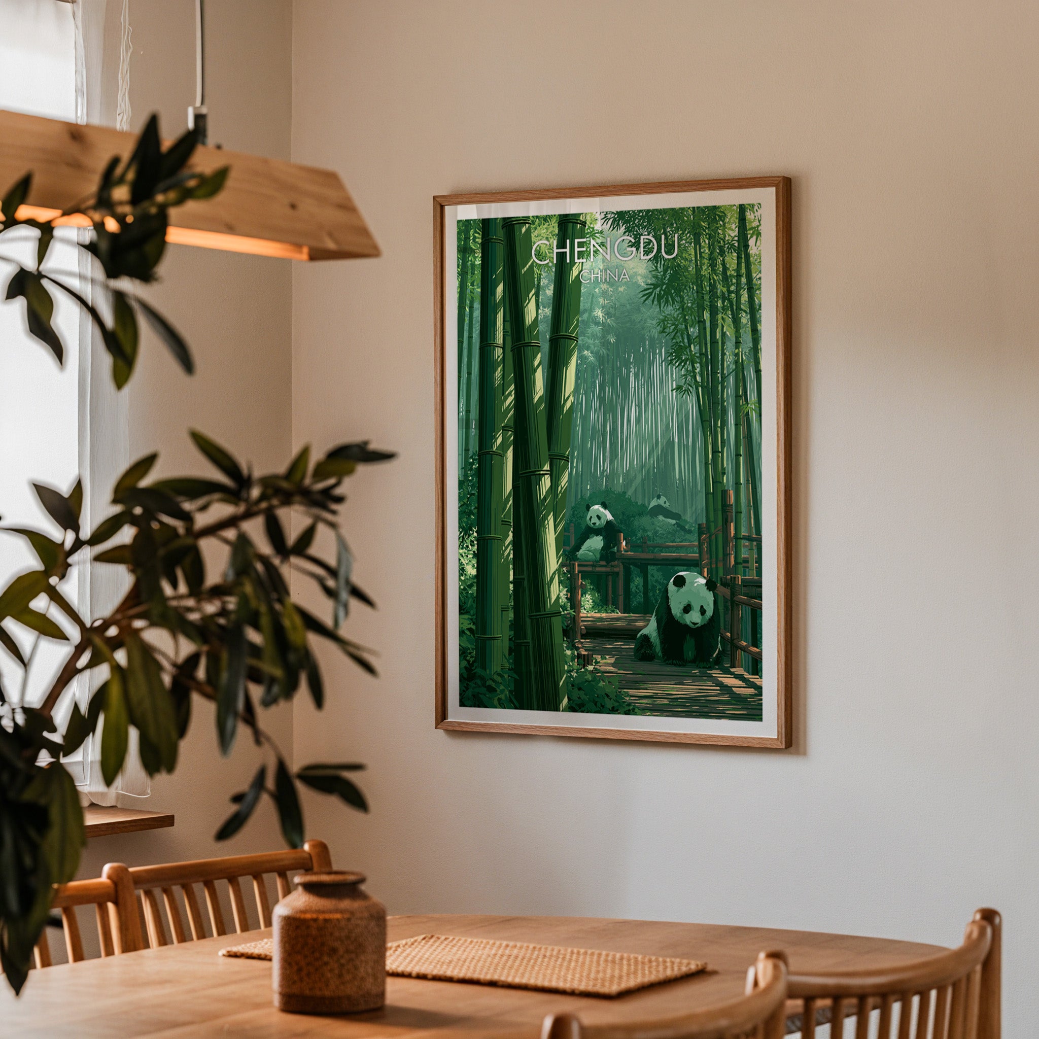 Framed Giant Pandas Chengdu China print on a dining room wall above an oak table in warm afternoon light